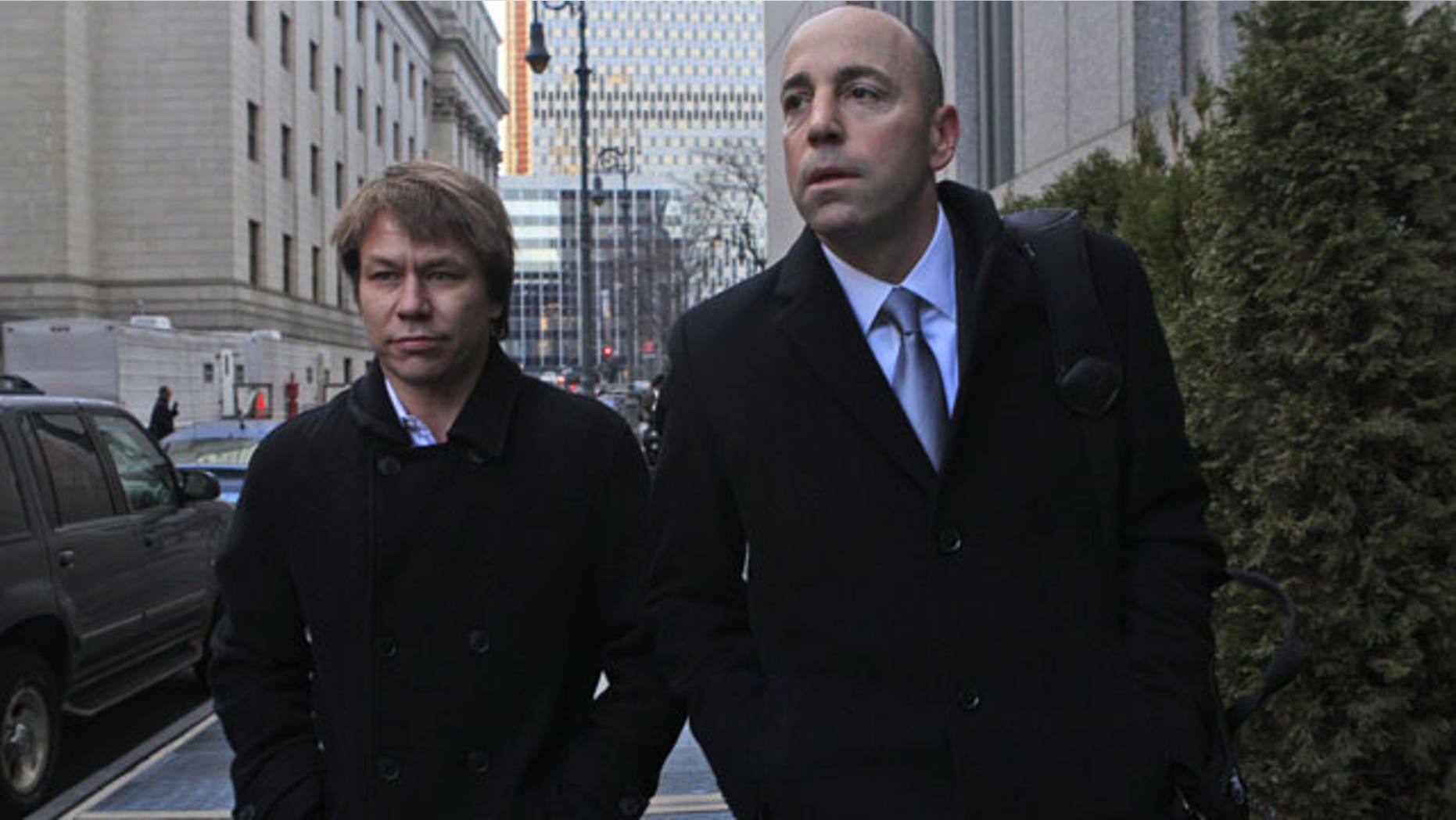 January, 18, 2012: Jon Horvath, left, an analyst at Sigma Capital Management leaves Manhattan Federal court in New York with his attorney. A hedge fund co-founder, four financial analysts and a Dell Inc. employee teamed up in a record-setting insider trading scheme that netted more than $61.8 million in illegal profits based on trades of a single stock, authorities said Wednesday.