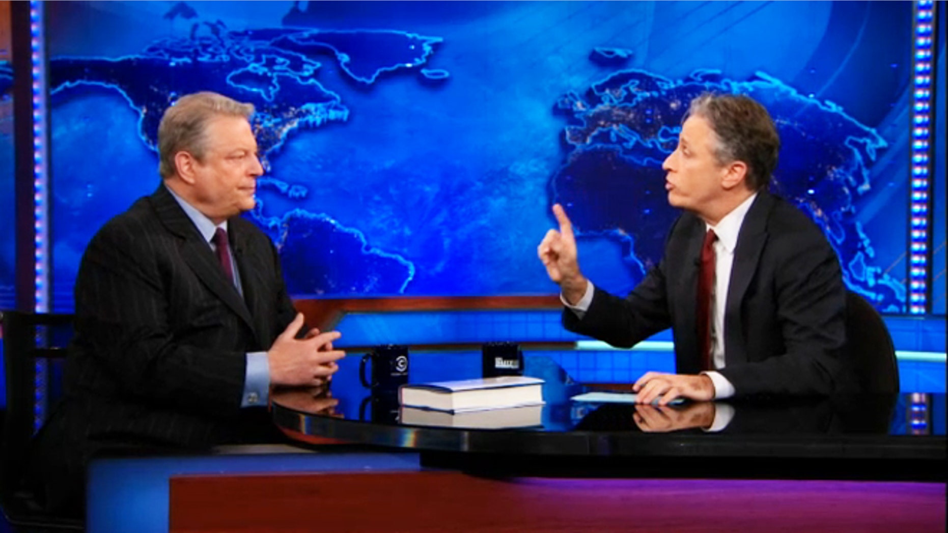 Al Gore, left, sits down with Jon Stewart to discuss Current TV and Al Jazeera on "The Daily Show."