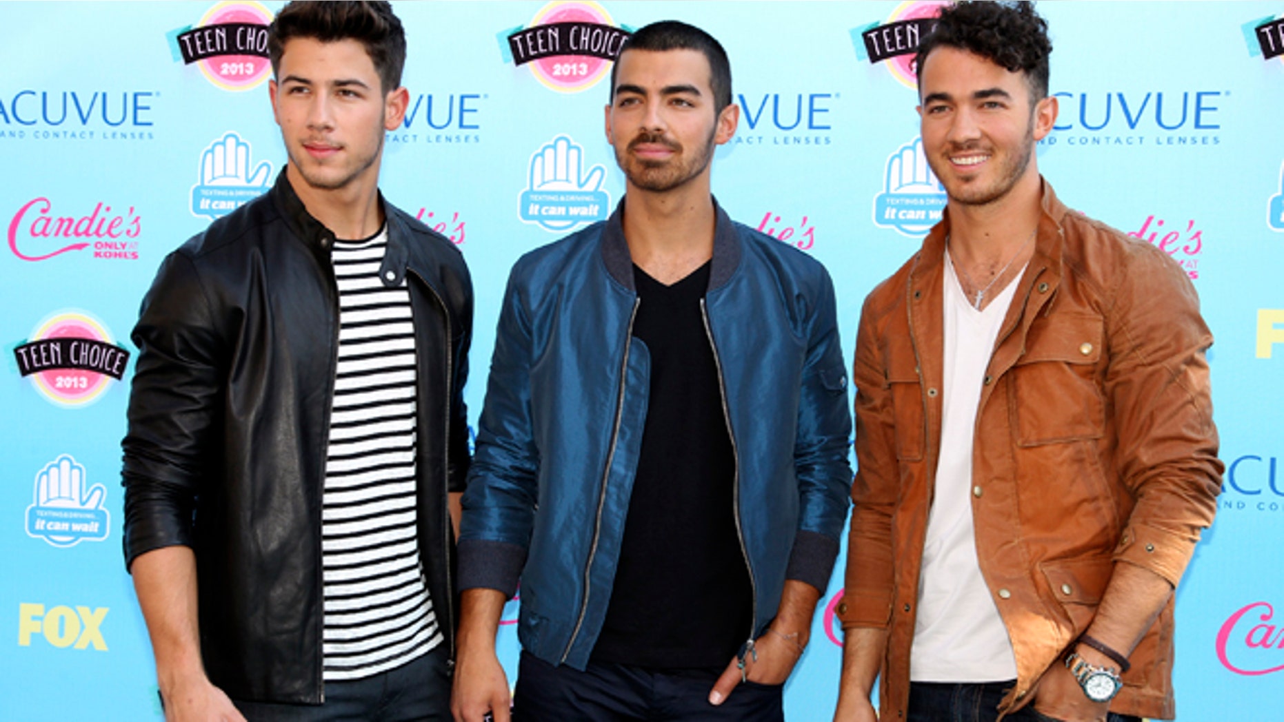 Nick, Joe and Kevin Jonas pose as they arrive at the Teen Choice Awards at the Gibson amphitheatre in Universal City, California August 11, 2013.
