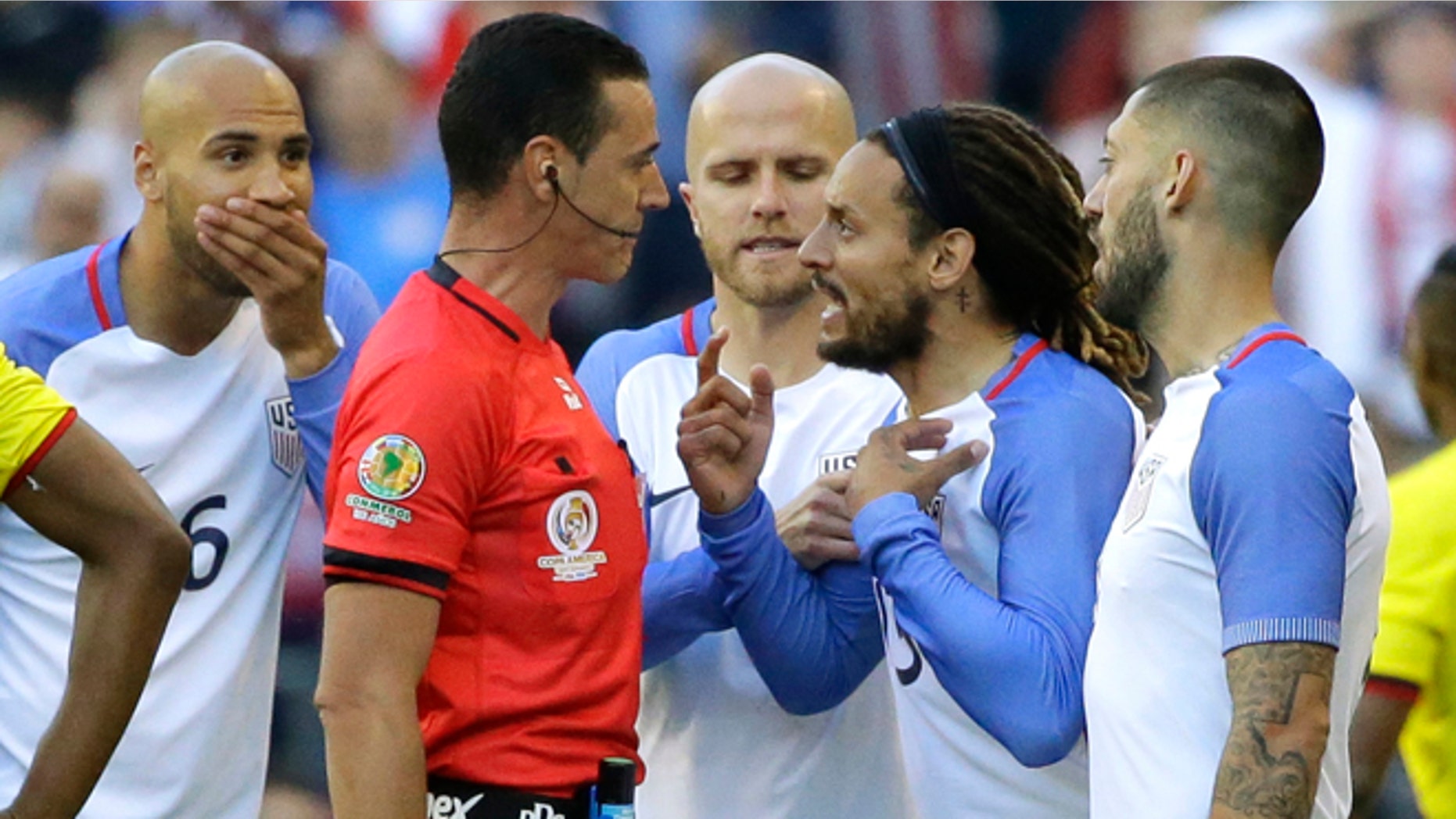 United States midfielder Jermaine Jones, second from right, protests to referee Wilmar Roldan, second from left, after Roldan gave Jones a red card in the second half of a Copa America Centenario soccer match against Ecuador, Thursday, June 16, 2016 at CenturyLink Field in Seattle. The United States beat Ecuador 2-1. (AP Photo/Ted S. Warren)