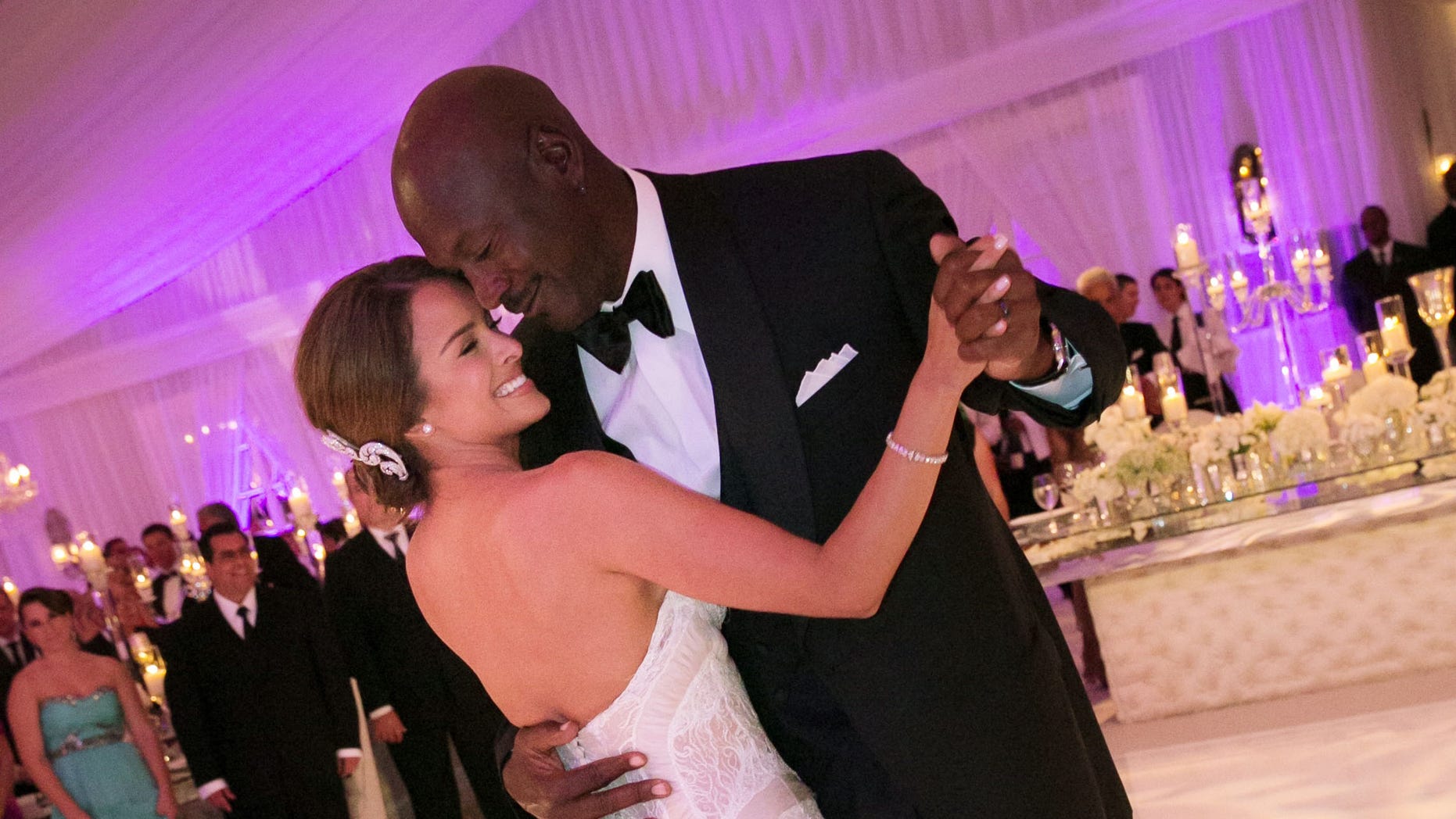 In this Saturday, April 27, 2013, photo provided by JUMP.DC, Charlotte Bobcats owner Michael Jordan dances with his bride Yvette Prieto during their wedding reception at the Bear's Club in Jupiter, Fla. The wedding took place at the Episcopal Church of Bethesda-by-the-Sea with more than 300 guests in attendance, including Tiger Woods, Patrick Ewing and Ahmad Rashad, Jordan's manager Estee Portnoy told The Associated Press Sunday.