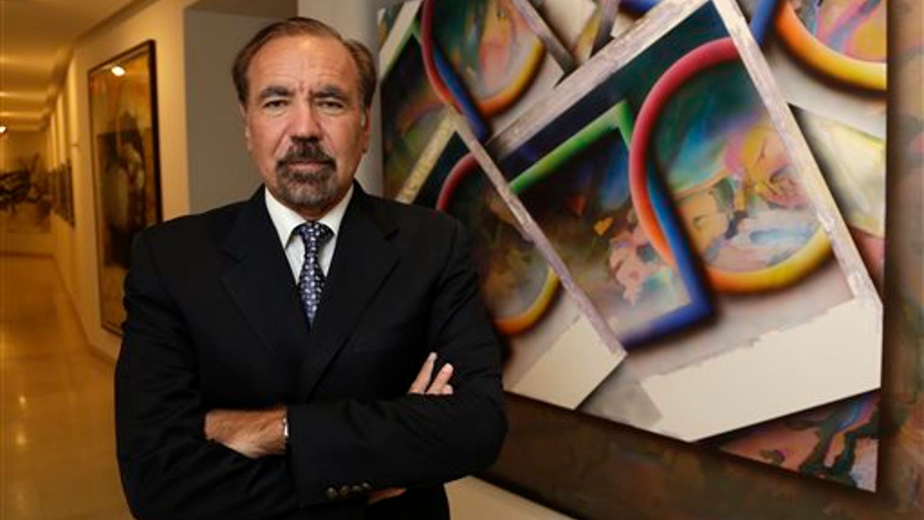 FILE- In this In this Dec. 11, 2013 file photo, developer and art collector Jorge Perez, poses for a photograph in his office at the Related Group, in Miami. Perez is one of Floridas powerful Cuban-American business leaders. He wants to soften the U.S. governments longtime economic embargo against Cubas communist government. (AP Photo/Lynne Sladky, File)
