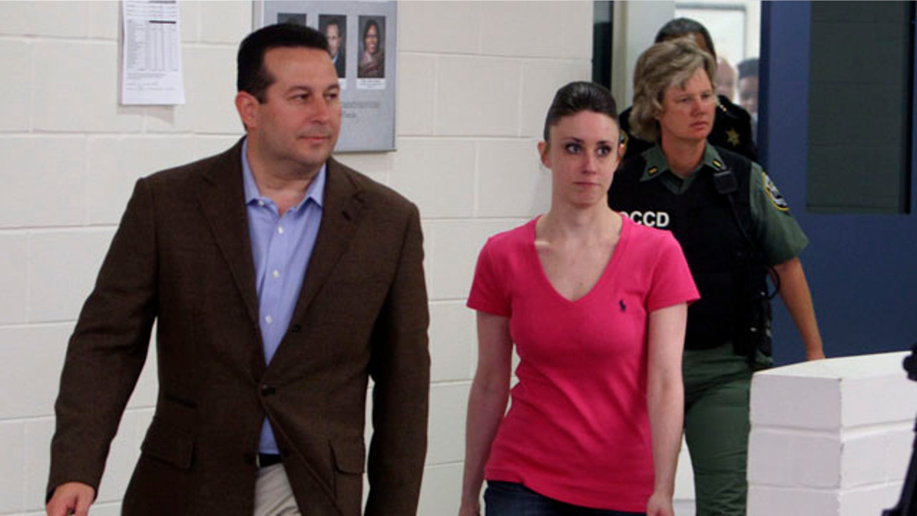 Casey Anthony, center, walks out of the Orange County Jail with her attorney Jose Baez, left, during her release in Orlando, Fla., early Sunday, July 17, 2011.