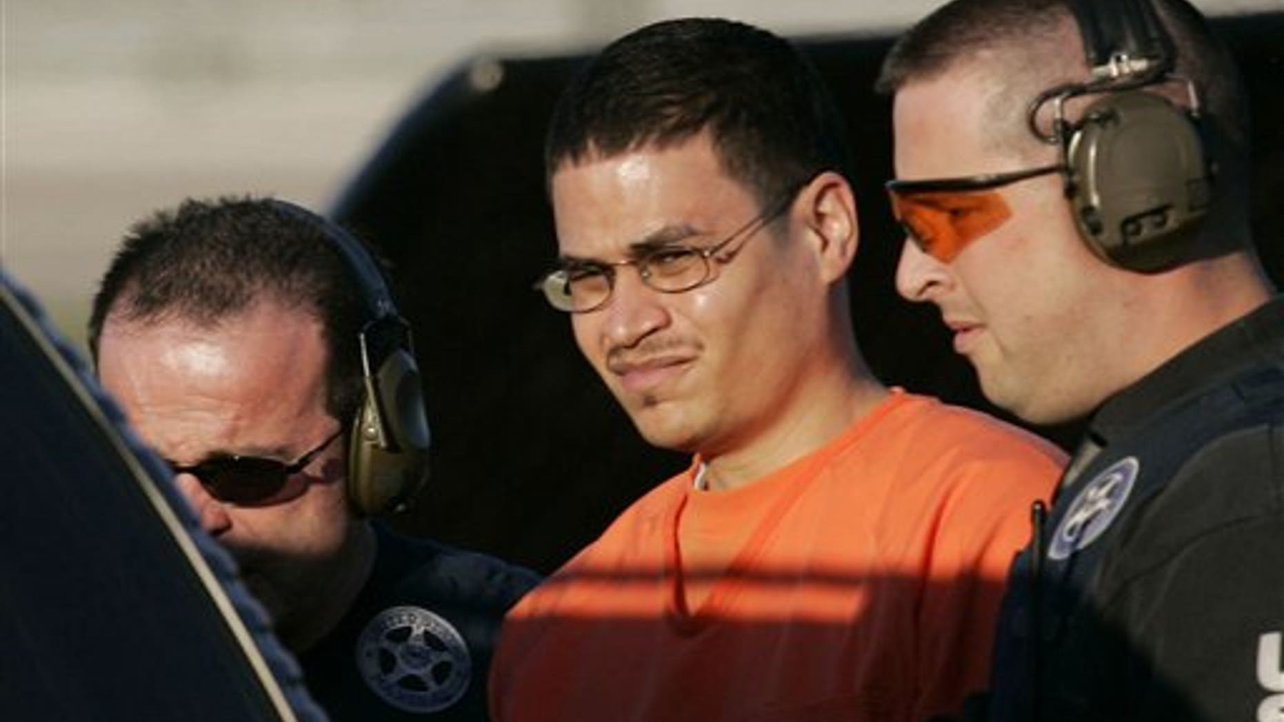 January 5, 2006: Jose Padilla is escorted to a waiting police vehicle by federal marshals near downtown Miami, FL.