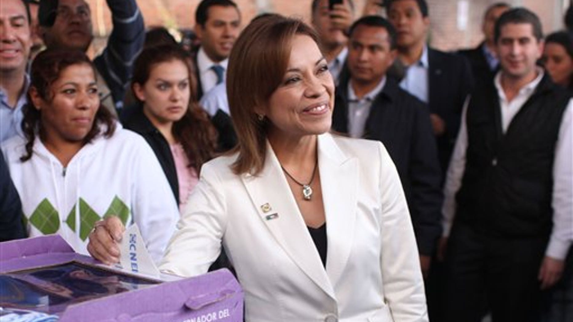 Josefina Vasquez Mota, center, presidential candidate of Mexico's National Action Party, PAN, casts her vote during the party's primary elections in Huixquilucan, Mexico, Sunday, Feb. 5, 2012. If nominated Vasquez Mota would be the first woman of a major political party to run for Mexico's highest office. (AP Photo/Alexandre Meneghini)