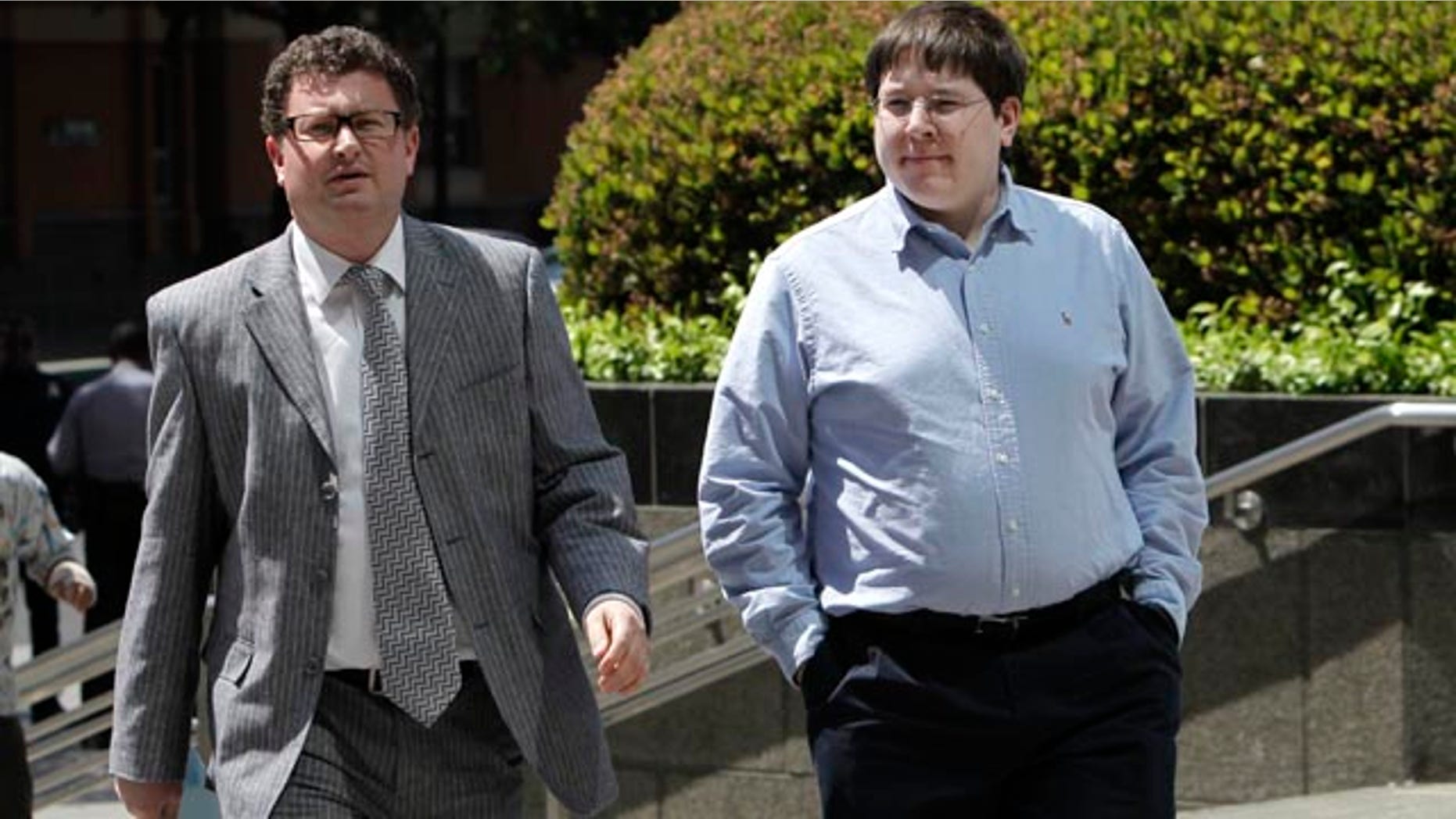 FILE -- In this April 23, 2013 file photo, Matthew Keys, right, who faces federal charges that he allegedly conspired with the hacking group Anonymous to break into the Los Angeles Times' website, walks to the federal courthouse for his arraignment with his attorney Jason Leiderman, in Sacramento, Calif. (AP Photo/Rich Pedroncelli,file)