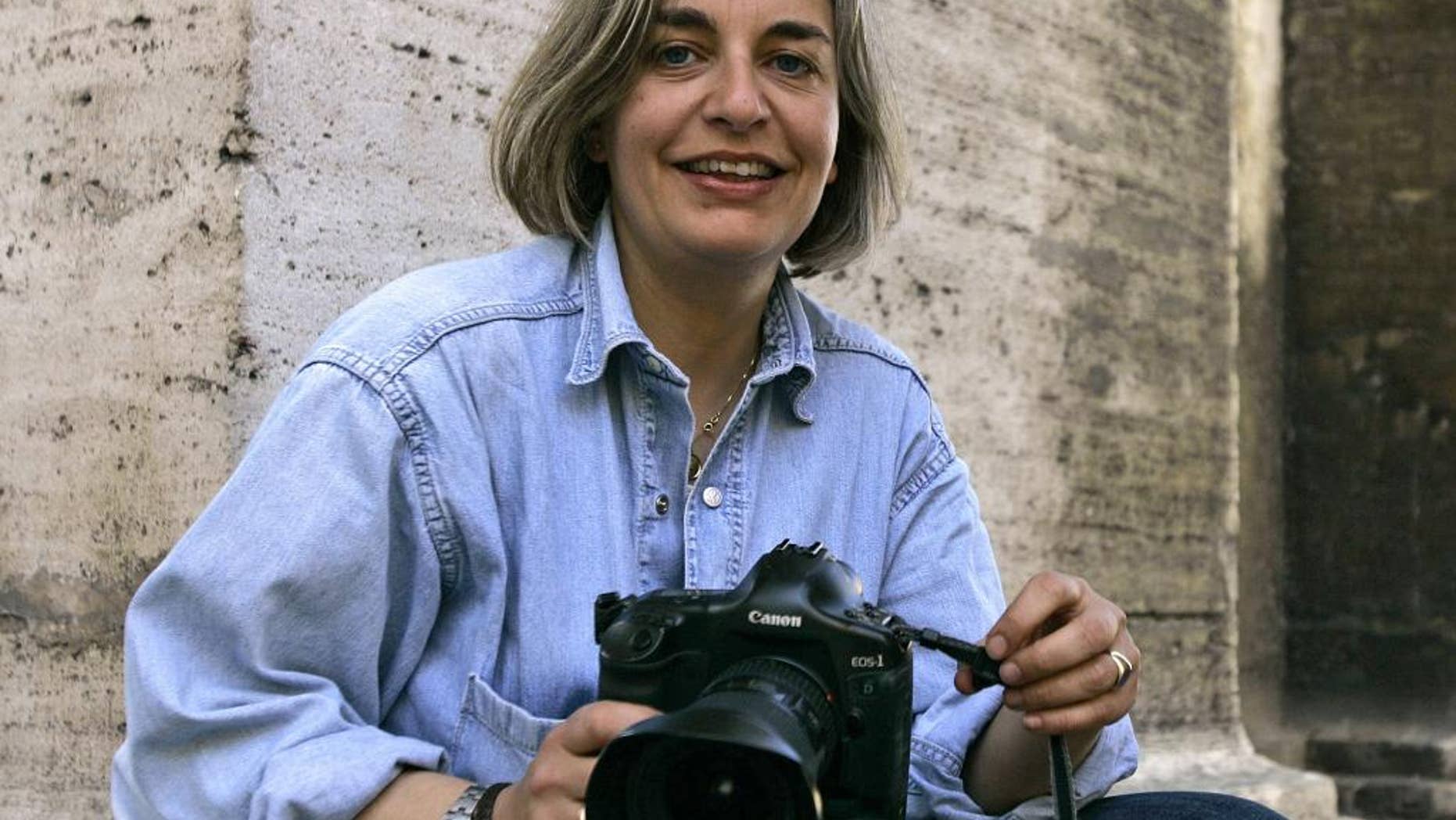 FILE - In this April 7, 2005 file photo, Associated Press photographer Anja Niedringhaus poses in Rome. Niedringhaus, 48, was killed and an AP reporter was wounded on April 4, 2014, when an Afghan policeman opened fire while they were sitting in their car in eastern Afghanistan. At least 60 journalists around the world were killed in 2014 while on the job or because of their work, and 44 percent of them were targeted for murder, the Committee to Protect Journalists says. (AP Photo/Peter Dejong, File)