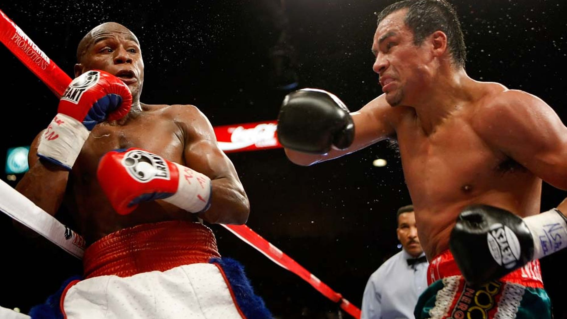LAS VEGAS - SEPTEMBER 19: Floyd Mayweather Jr. (L) and Juan Manuel Marquez exchange blows in the fourth round of their fight at the MGM Grand Garden Arena September 19, 2009 in Las Vegas, Nevada. Mayweather won by unanimous decision. (Photo by Ethan Miller/Getty Images)