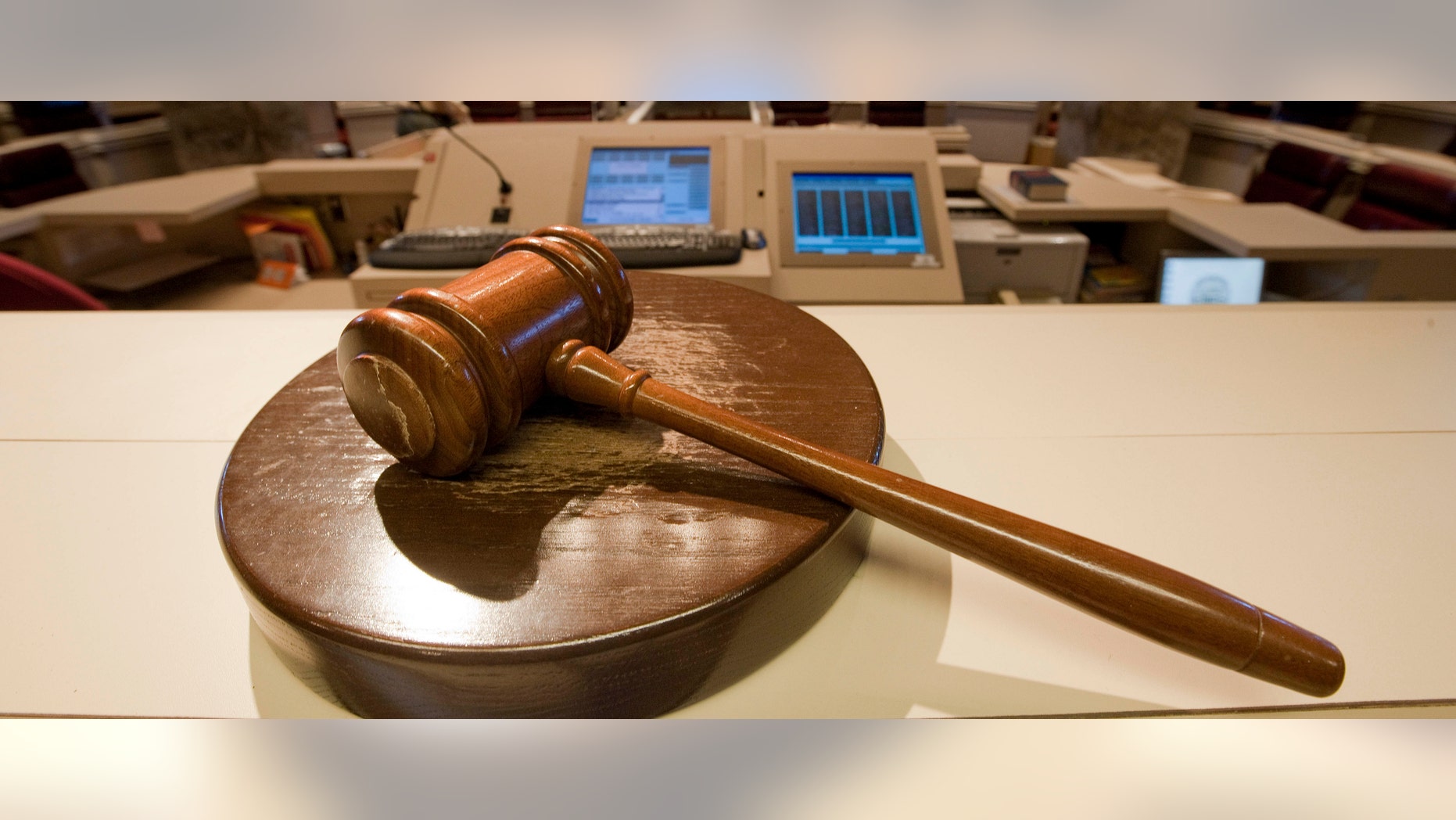The gavel stands ready as Alabama House Public Information Officer Clay Redden, rear, makes preparations House chamber in Montgomery, Ala., on Friday, Dec. 3, 2010 a for the special session on ethics legislation called by Gov. Bob Riley. The lawmakers come into session next Wednesday. (AP Photo/Dave Martin)