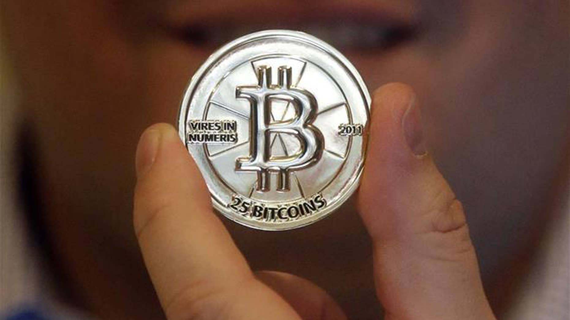 In this April 3, 2013, photo, a 25-bitcoin token is shown.