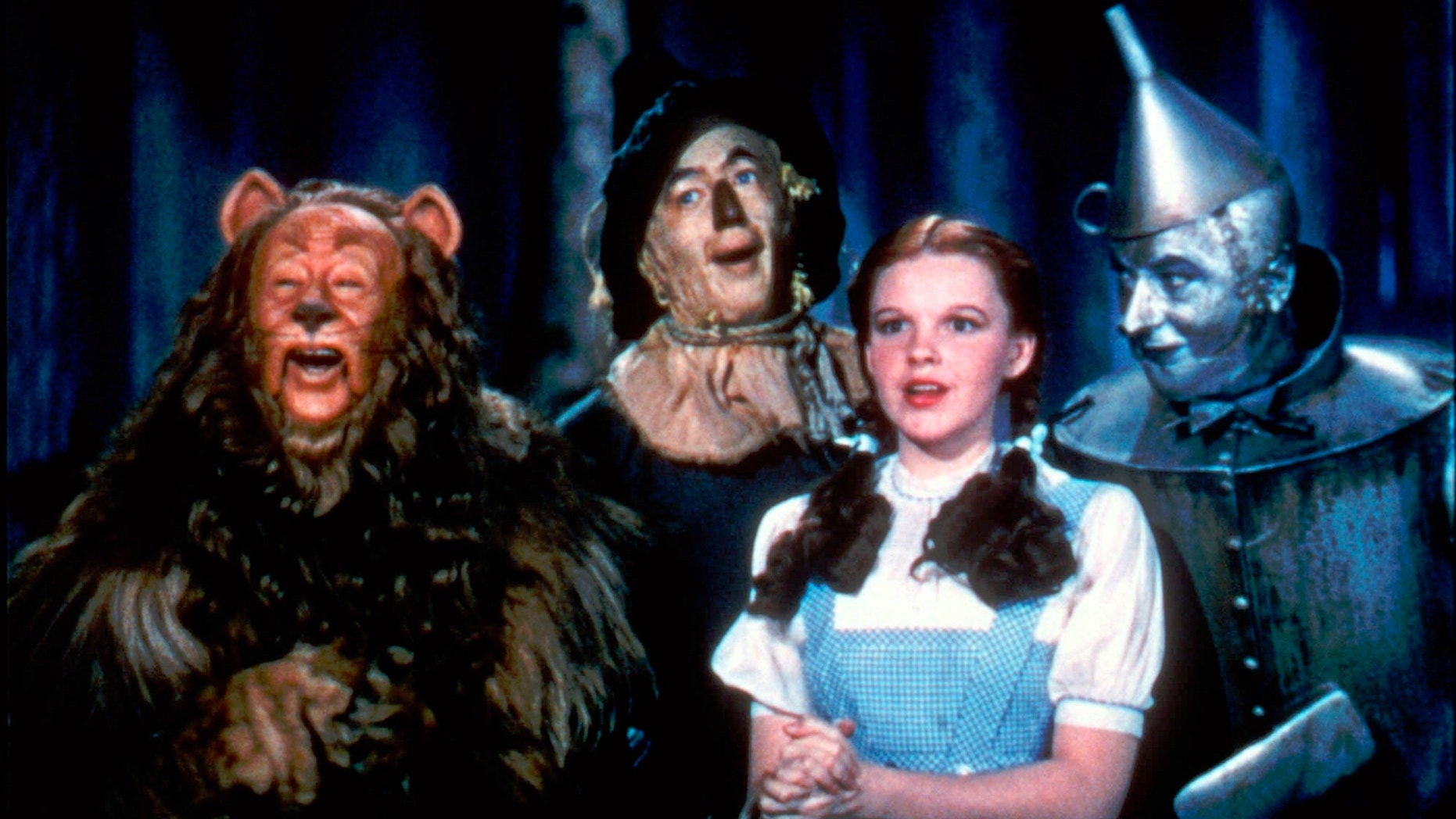 Bert Lahr as the Cowardly Lion, Ray Bolger as the Scarecrow, Judy Garland as Dorothy and Jack Haley as the Tin Woodman in a scene from "The Wizard of Oz."