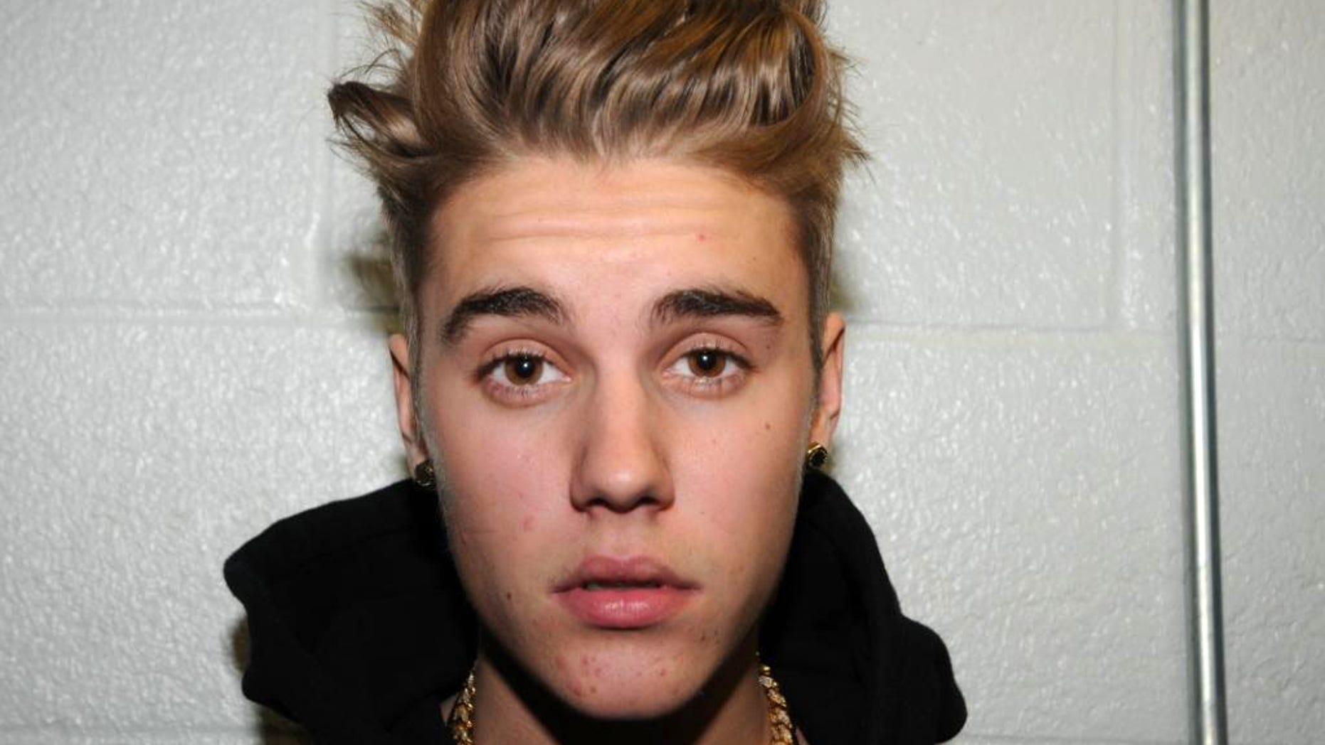 FILE - This Jan. 23, 2014 file photo made available by the Miami Beach Police Dept., shows Justin Bieber at the police station in Miami Beach, Fla. A new trial date could be set for Bieber in the Florida case charging him with driving under the influence, resisting arrest and possessing an invalid driver's license. A hearing was scheduled Tuesday, March 11, 2014, for the 20-year-old pop singer, who has pleaded not guilty. A previous trial date was postponed while attorneys for news organizations and Bieber wrestled with releasing police videos of him giving a drug test urine sample. (AP Photo/Miami Beach Police Dept., File)