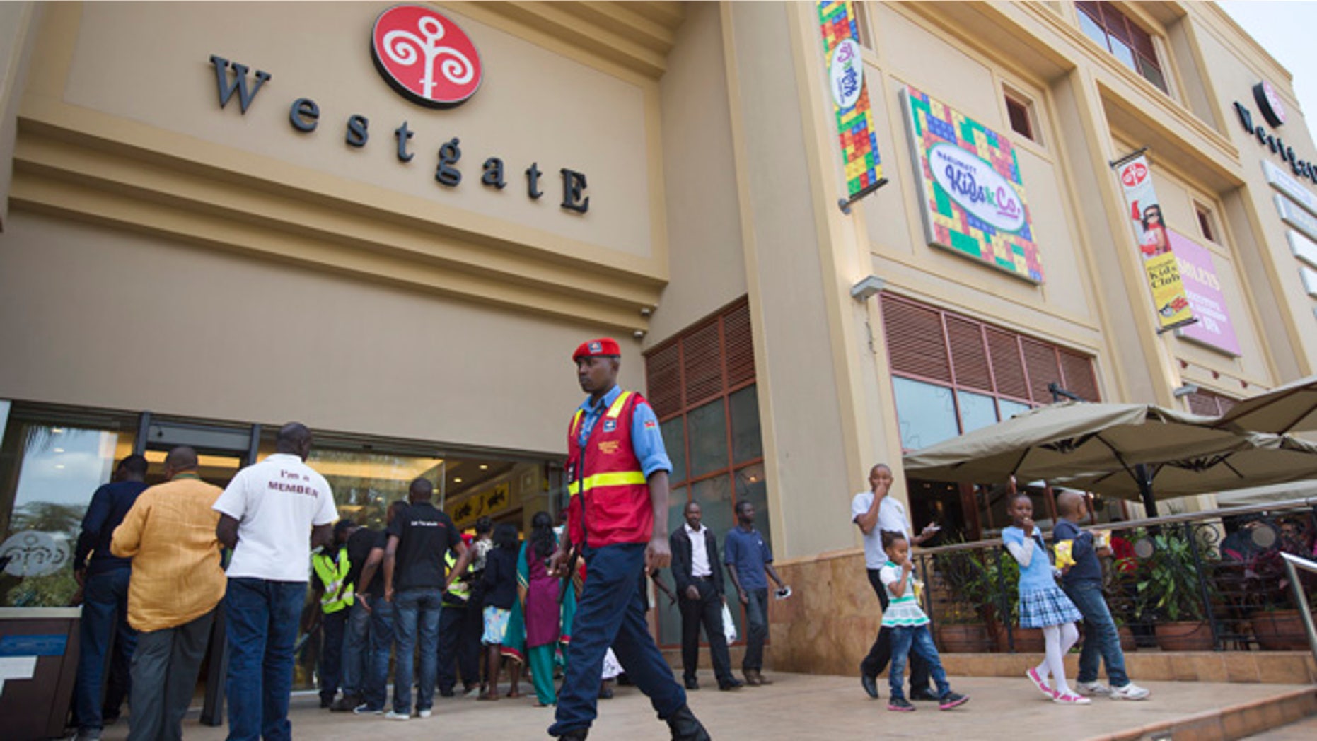 A security guard patrols outside the reopened Westgate Shopping Mall, nearly two years after a terrorist attack there left at least 67 people dead, in the capital Nairobi, Kenya Saturday, July 18, 2015. Hundreds of shoppers thronged through the reopened mall Saturday, following two years of repairs after security forces battled four gunmen from Somalia's al-Qaida-linked al-Shabab militant group there in September 2013. (AP Photo/Ben Curtis)