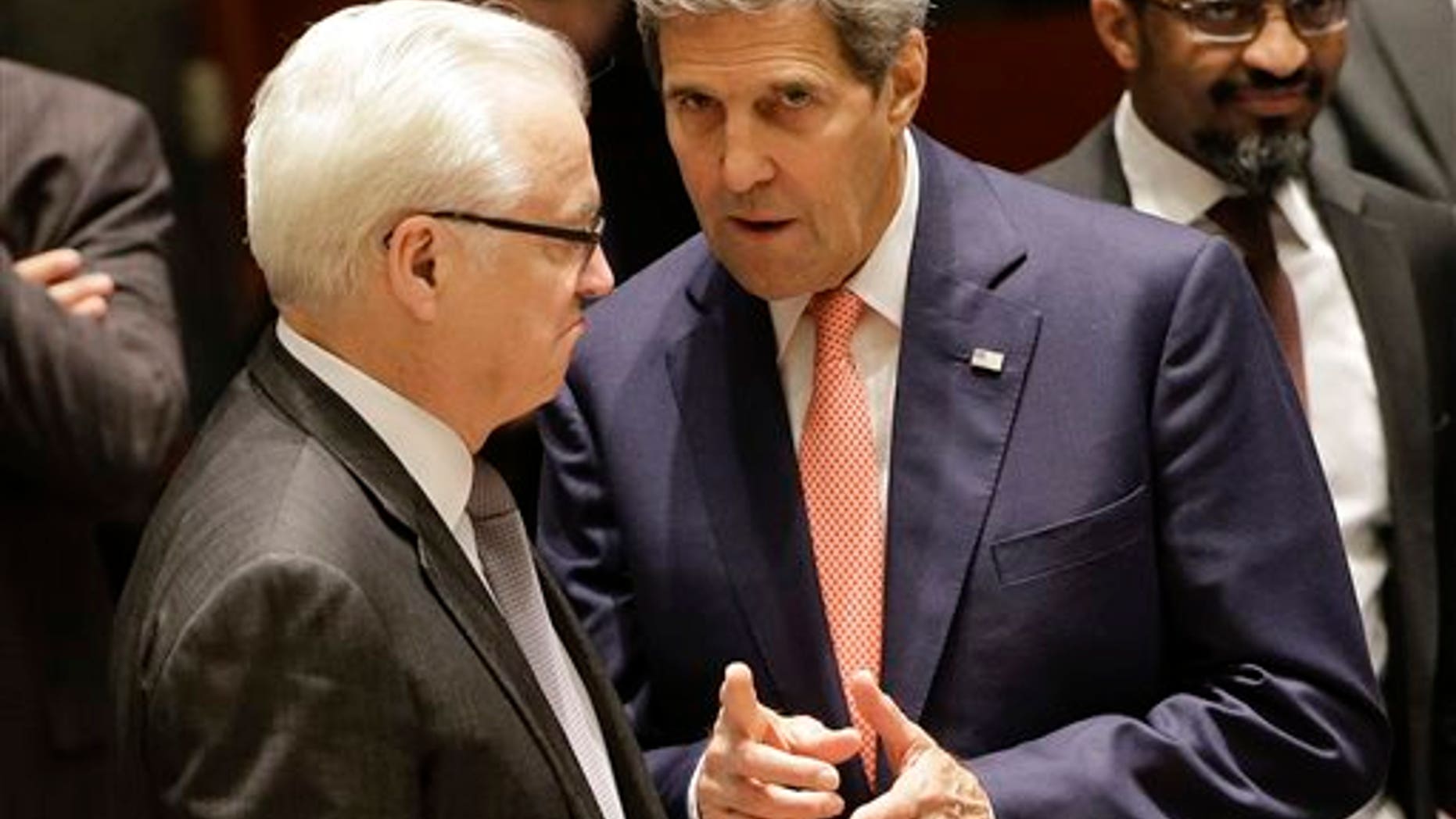 U.S. Secretary of State John Kerry, right, talks with Vitaly Churkin, Russian permanent resident to the United Nations, before a meeting of the U.N. Security Council, Friday, Sept. 19, 2014, at United Nations headquarters. The security council met Friday to discuss the situation in Iraq. (AP Photo/Julie Jacobson)