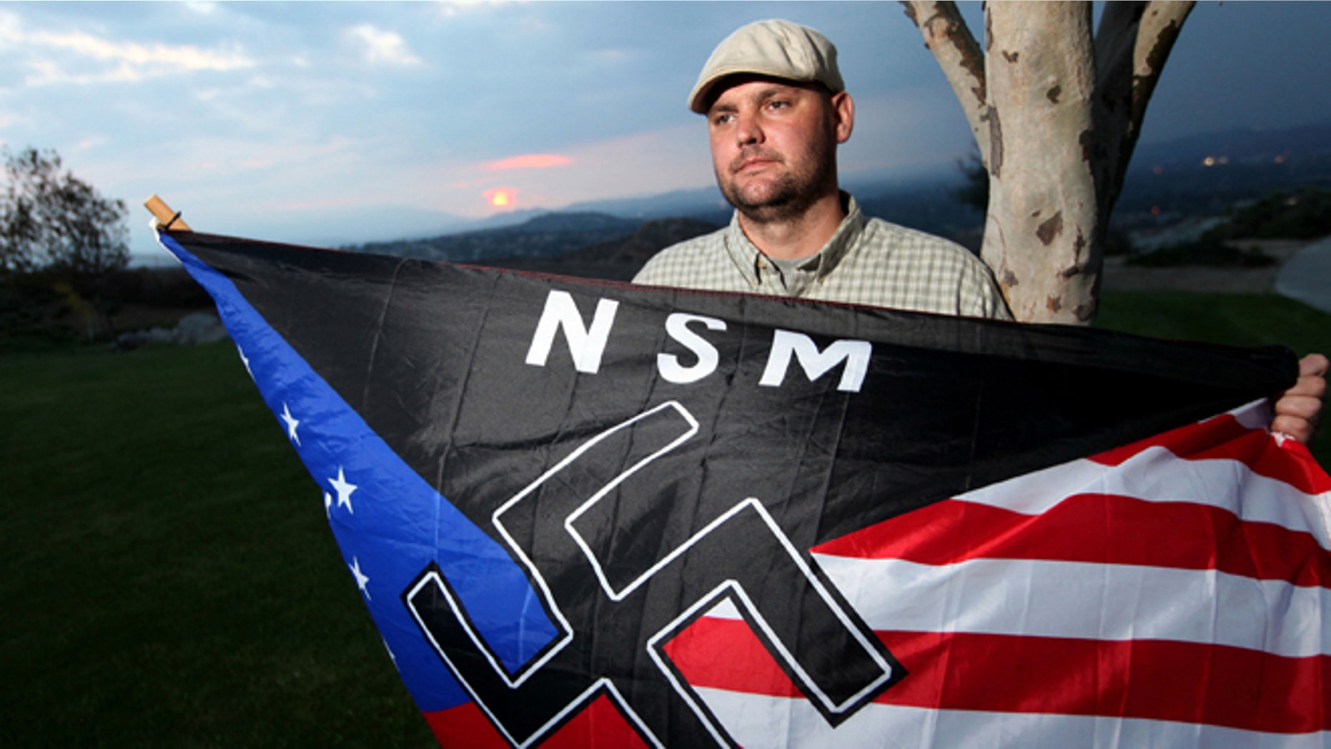 Oct. 22, 2010: Jeff Hall, who was killed by his son, holds a Neo Nazi flag while standing at Sycamore Highlands Park near his home in Riverside, Calif. (AP)