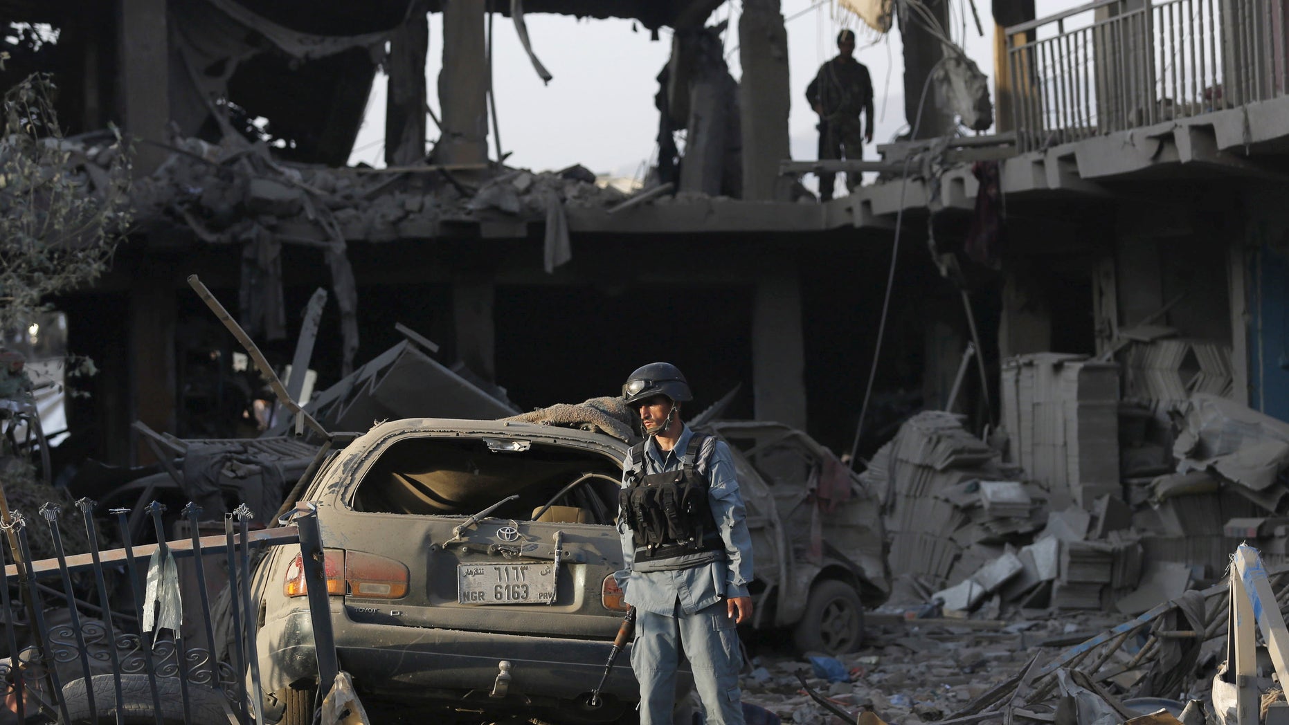 August 7, 2015 - An Afghan policeman at the site of a truck bomb attack in Kabul, Afghanistan. The truck bomb exploded near an army compound in the center of the Afghan capital, killing at least 15 and wounding hundreds police and health ministry officials said.