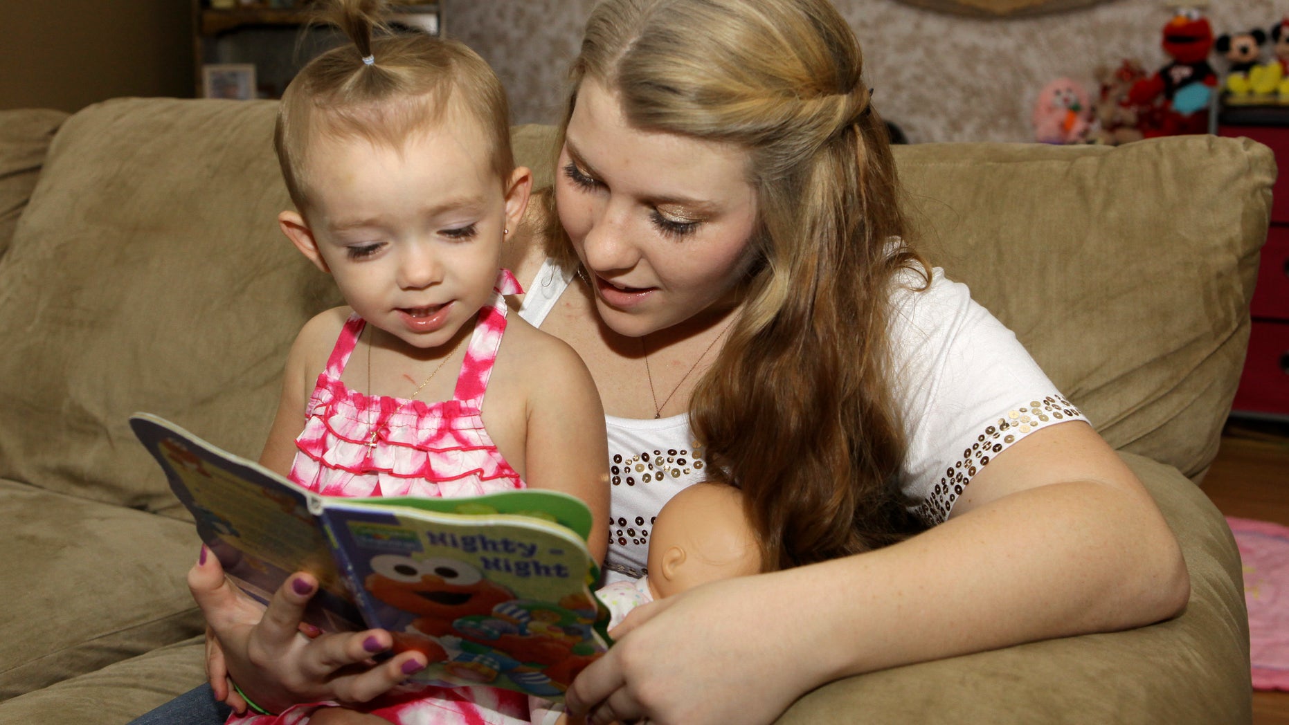 Kali Gonzalez reads to her daughter Kiah, 2, at their home in St. Augustine, Fla.