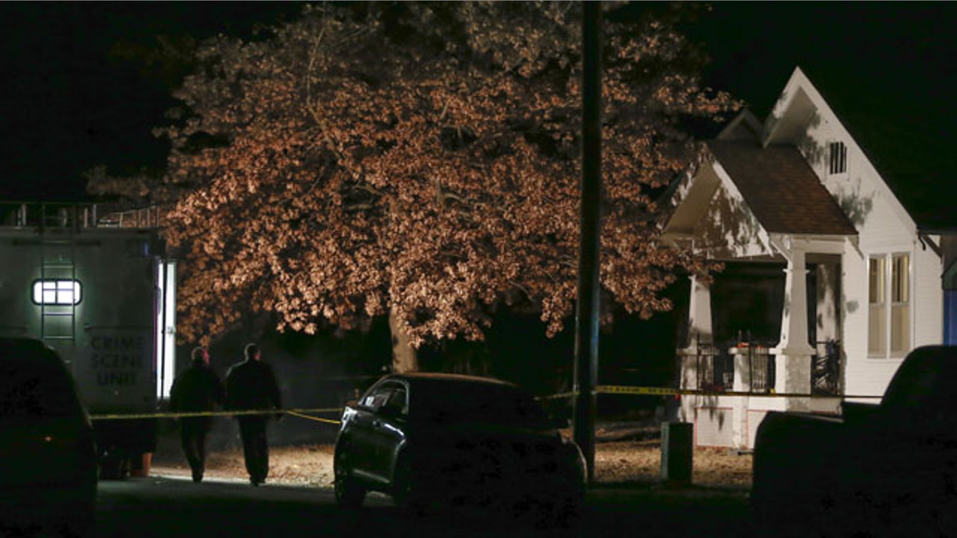 November 27, 2013: An active crime scene investigation is still underway in Parsons, Kan., where Cami Umbarger and her three young children – Hollie, Jaxon and Averie -- were found murdered in their home on Monday. (AP Photo/Wichita Eagle)