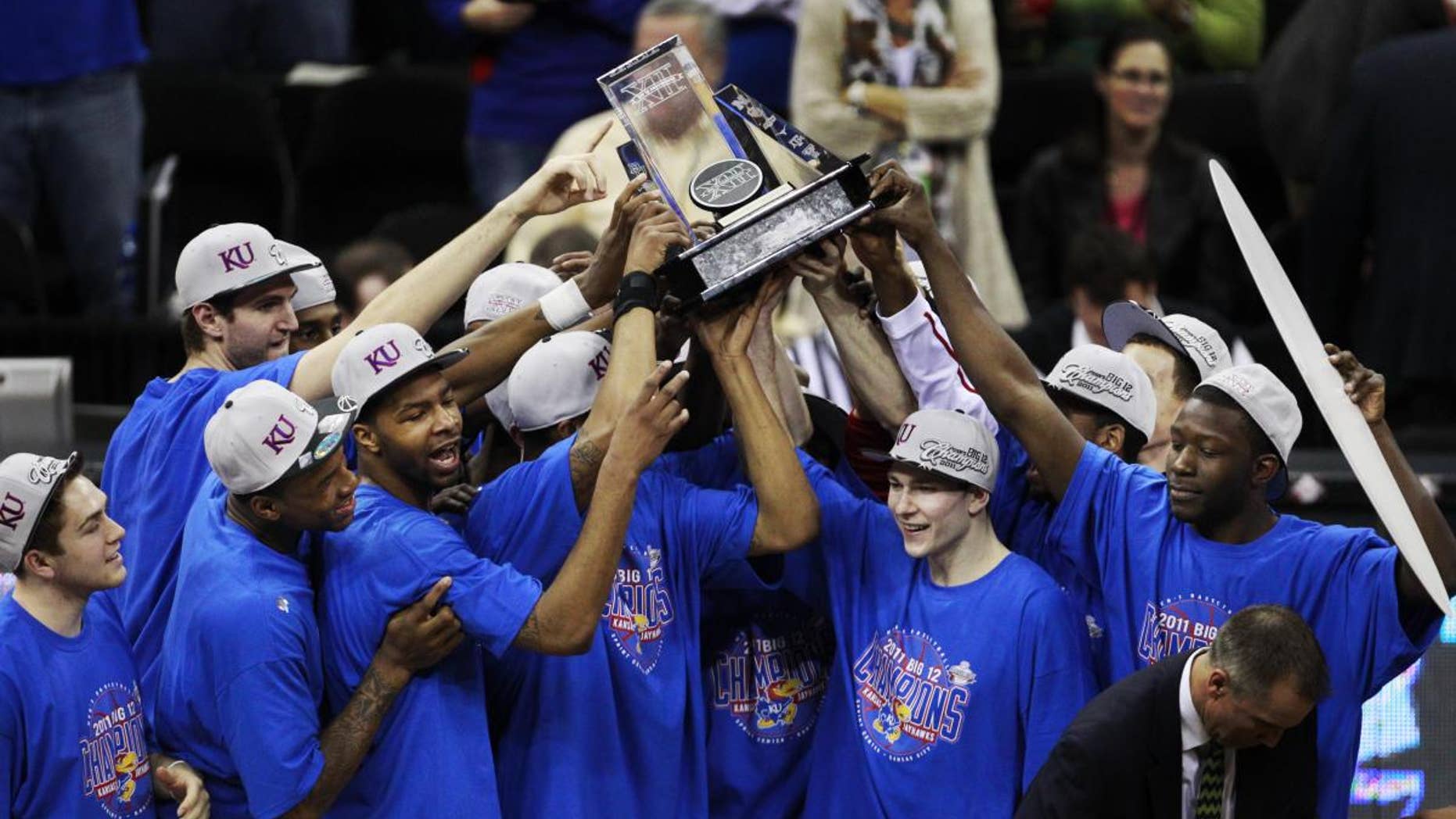The Kansas Jayhawks celebrate winning the final of the Big 12 men's basketball tournament against Texas in Kansas City, Mo., Saturday, March 12, 2011. (AP Photo/Orlin Wagner)