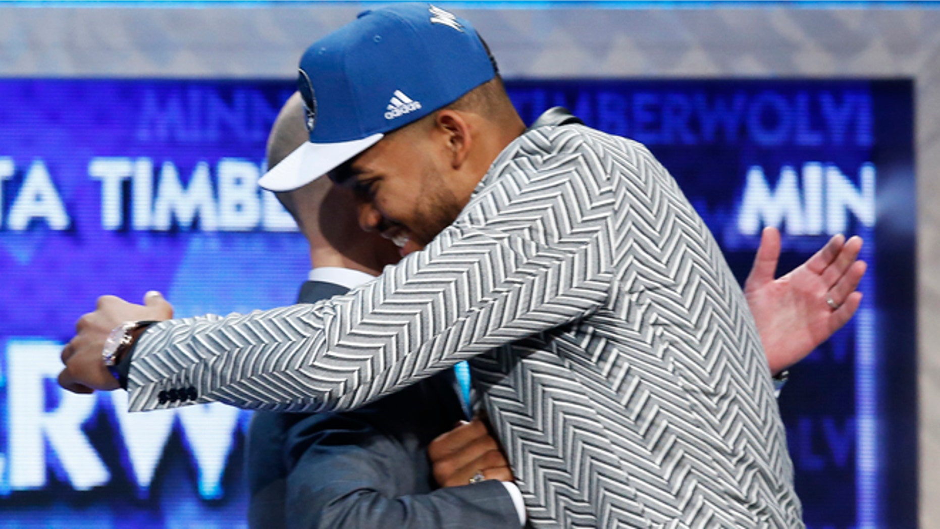 Karl-Anthony Towns, right, is greeted by NBA Commissioner Adam Silver after the Minnesota Timberwolves selected Towns, a Kentucky center, with the top pick in the NBA basketball draft, Thursday, June 25, 2015, in New York. (AP Photo/Kathy Willens)