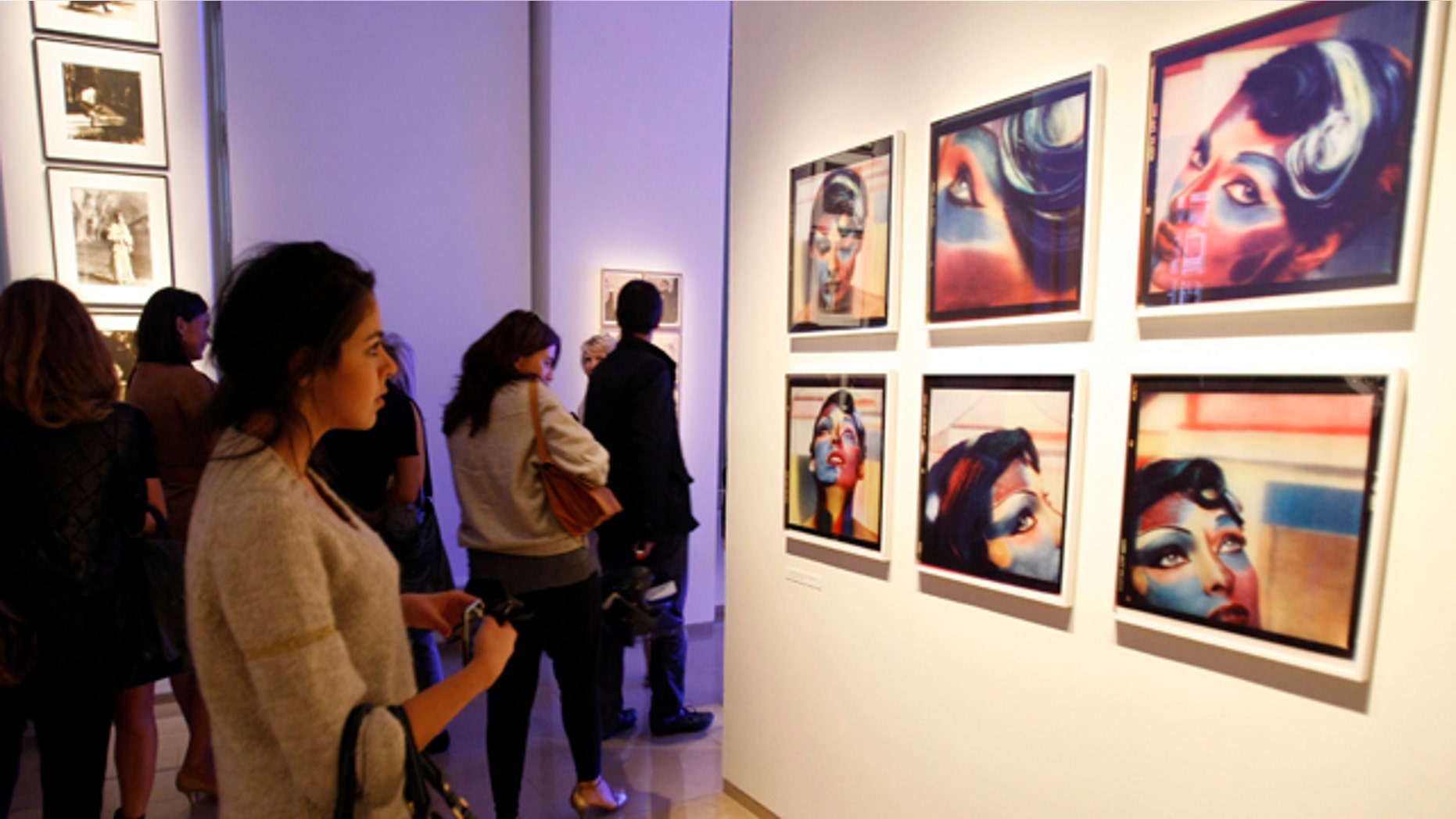 September 14:Guests look at photos by German fashion designer Karl Lagerfeld during the opening of his photo exhibition "Karl Lagerfeld, parcours de travail" at the European House of Photography in Paris, France. (AP)