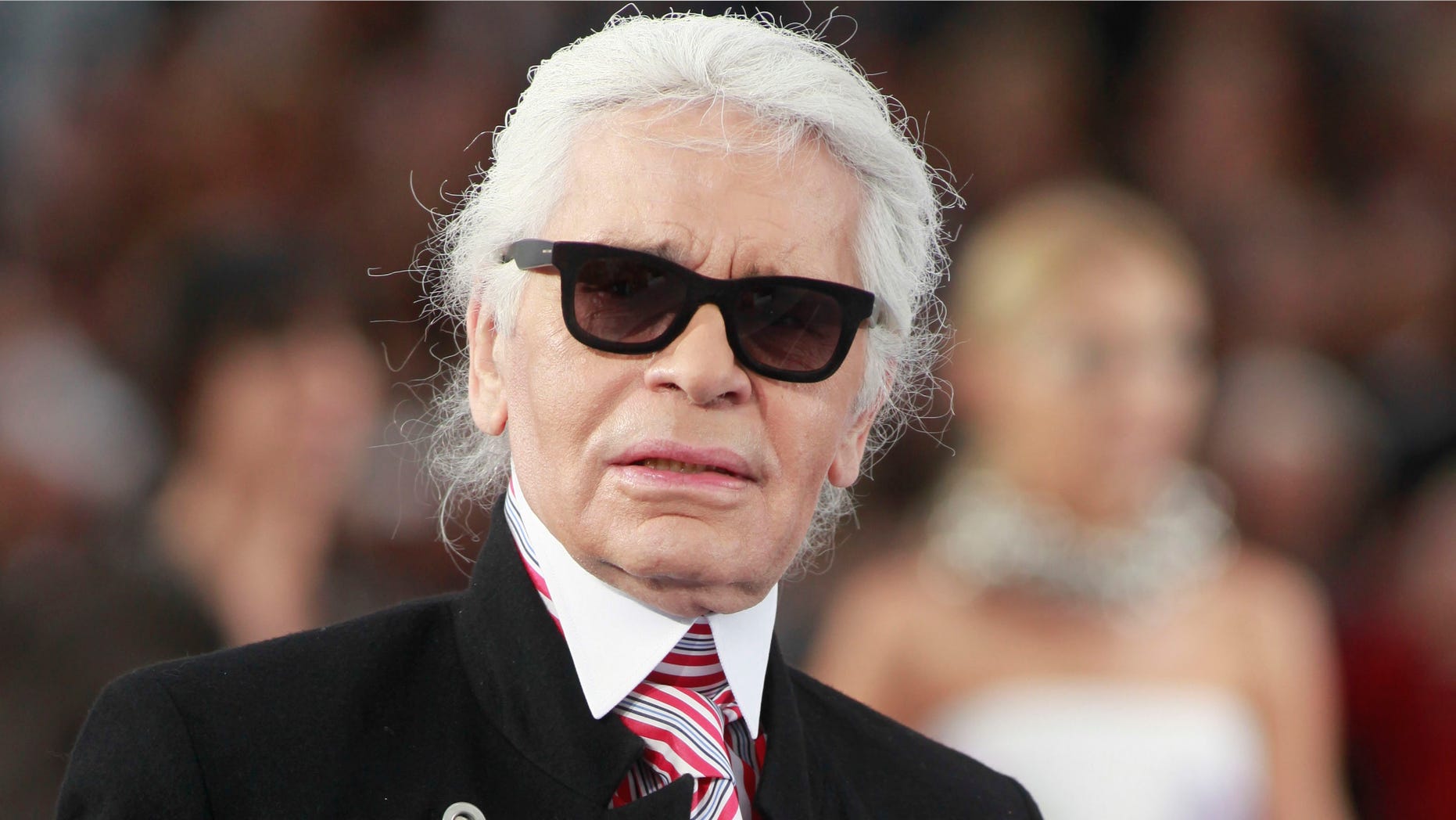 FILE - In this Oct.2, 2012 file photo, designer Karl Lagerfeld walks onto the runway after presenting Chanel's ready to wear Spring-Summer 2013 collection, presented in Paris.