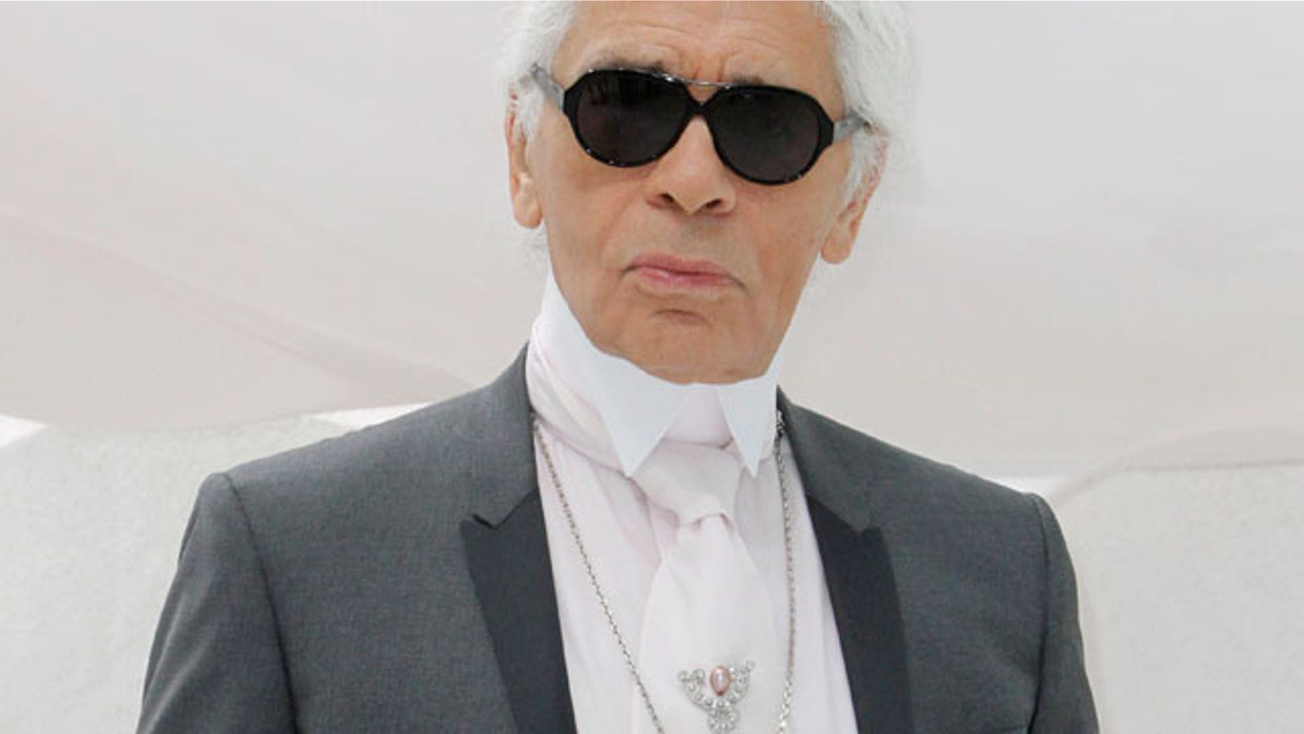 FILE - This Oct.4, 2011 file photo shows German fashion designer Karl Lagerfeld posing before Chanel's spring-summer 2012 ready to wear collection in Paris.