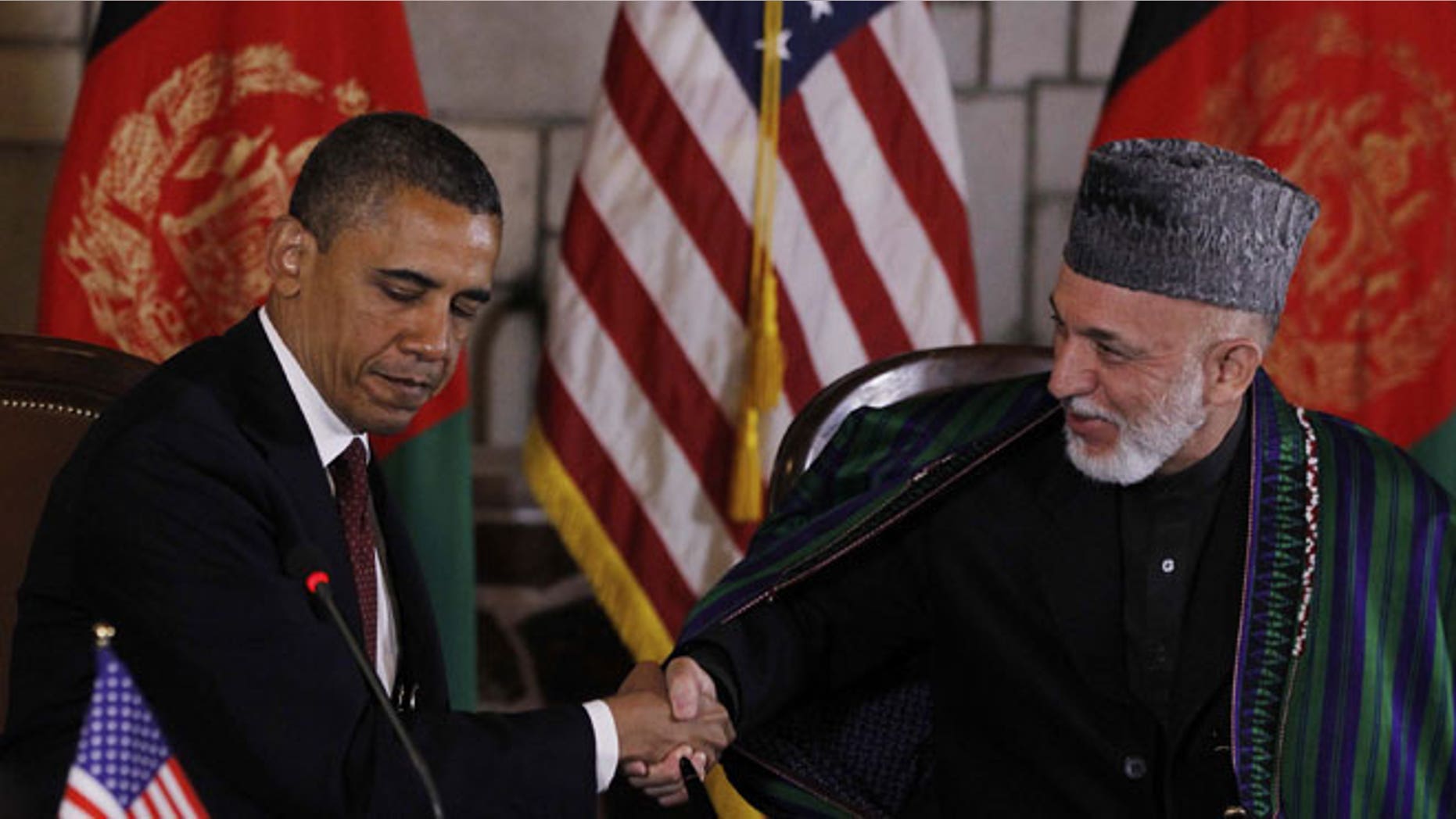 May 2, 2012: President Barack Obama and Afghan President Hamid Karzai shake hands after making statements before signing a strategic partnership agreement at the presidential palace in Kabul, Afghanistan.