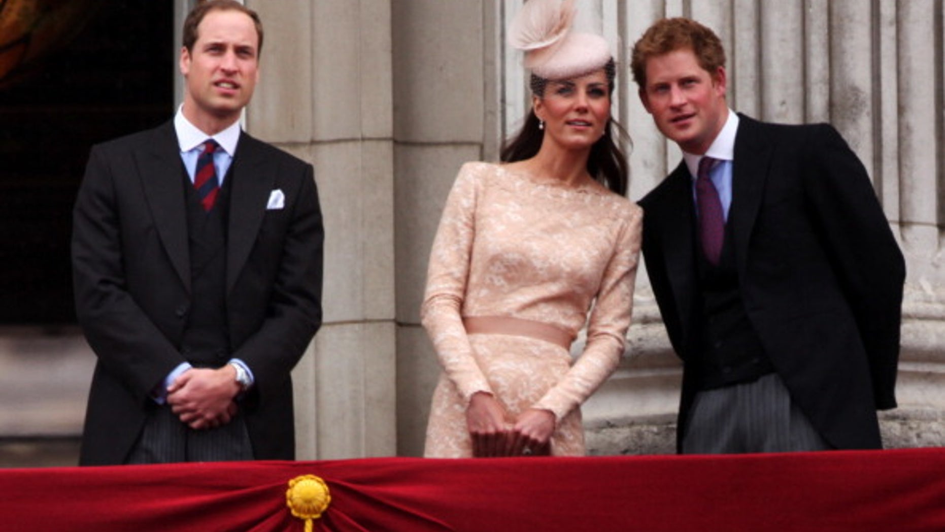 Prince William, Duke of Cambridge, Catherine, Duchess of Cambridge and Price Harry wave to the crowds from Buckingham Palace.