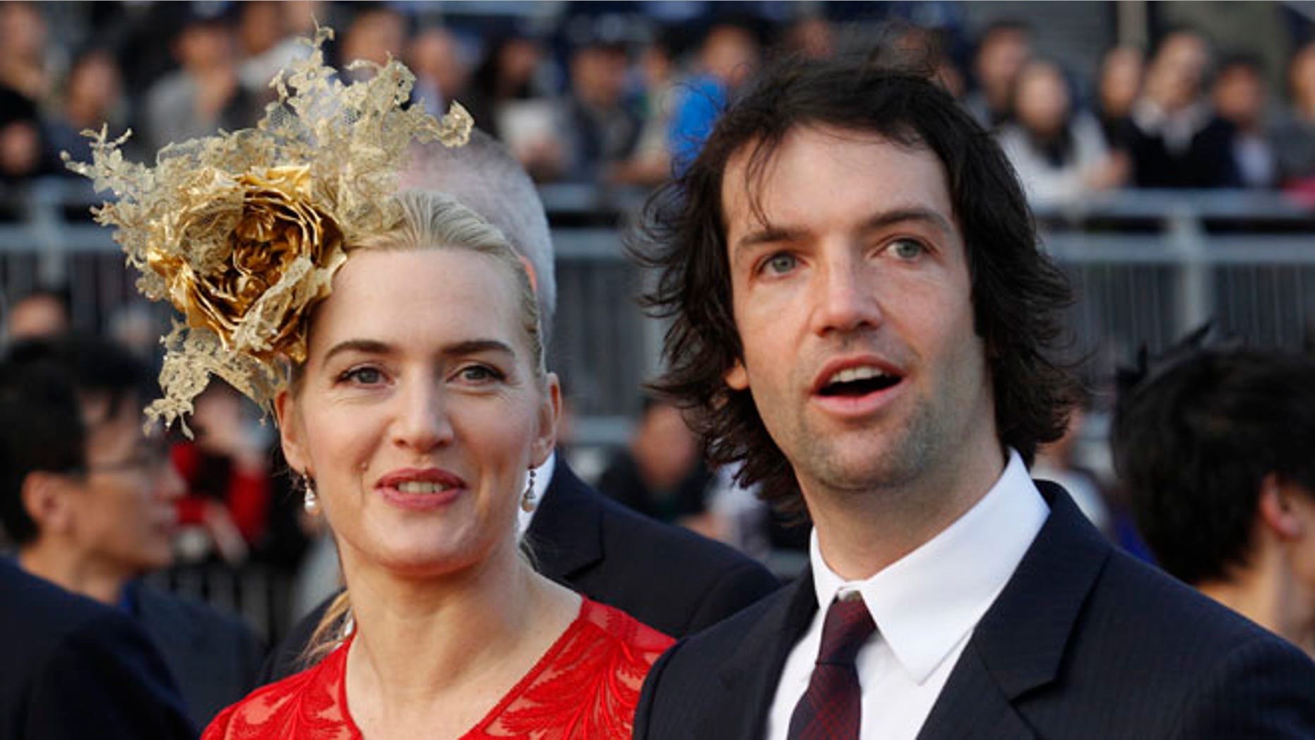 Dec. 9, 2012: In this file photo, British actress Kate Winslet, left, arrives with Ned Rocknroll at the awards presentation of The Longines Hong Kong Cup horse race at the Shatin race track in Hong Kong.