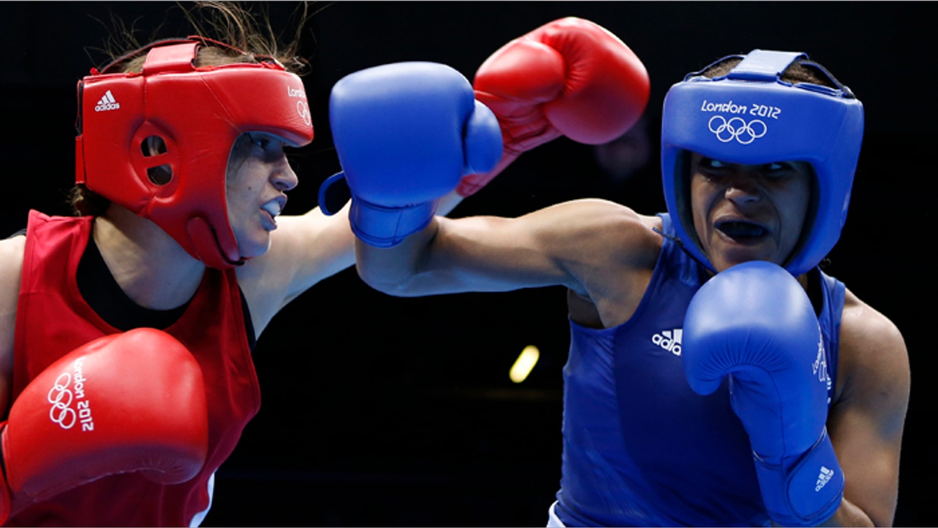 Ireland's Katie Taylor (L) fights Britain's Natasha Jonas during their quarterfinal Women's Light (60kg) boxing match at the London Olympic Games.