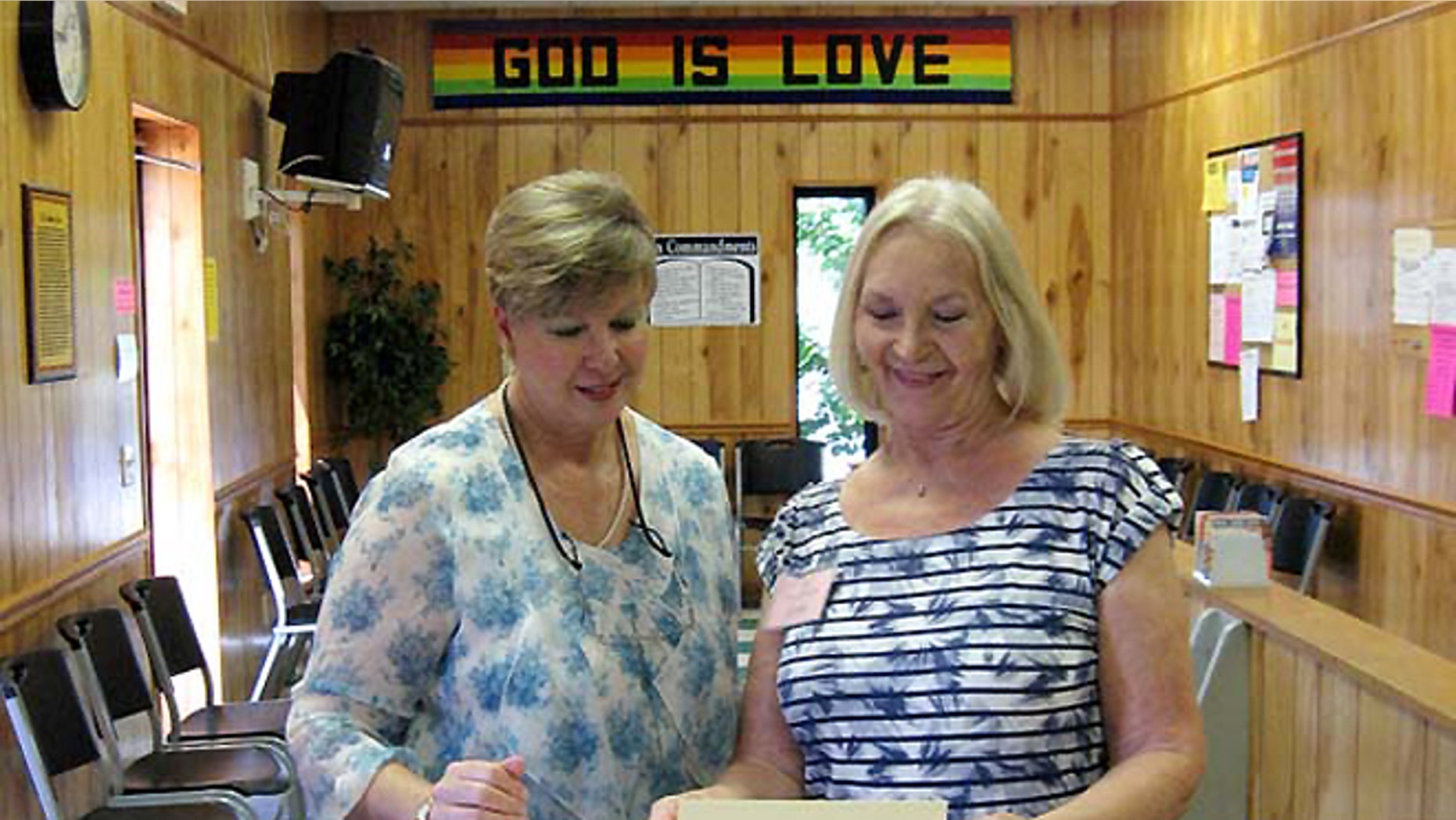 Christian Services Center Executive Director Kay Daly, left, works with a volunteer.