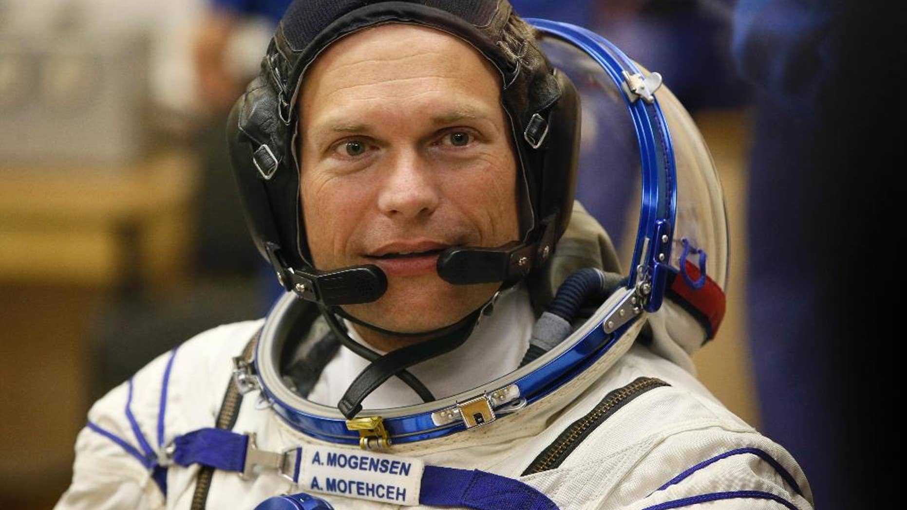 Denmark's astronaut Andreas Mogensen, member of the main crew of the expedition to the International Space Station (ISS), speaks with his family through a safety glass prior the launch of Soyuz-FG rocket at the Russian leased Baikonur cosmodrome, Kazakhstan, Wednesday, Sept. 2, 2015. (AP Photo/Dmitry Lovetsky)