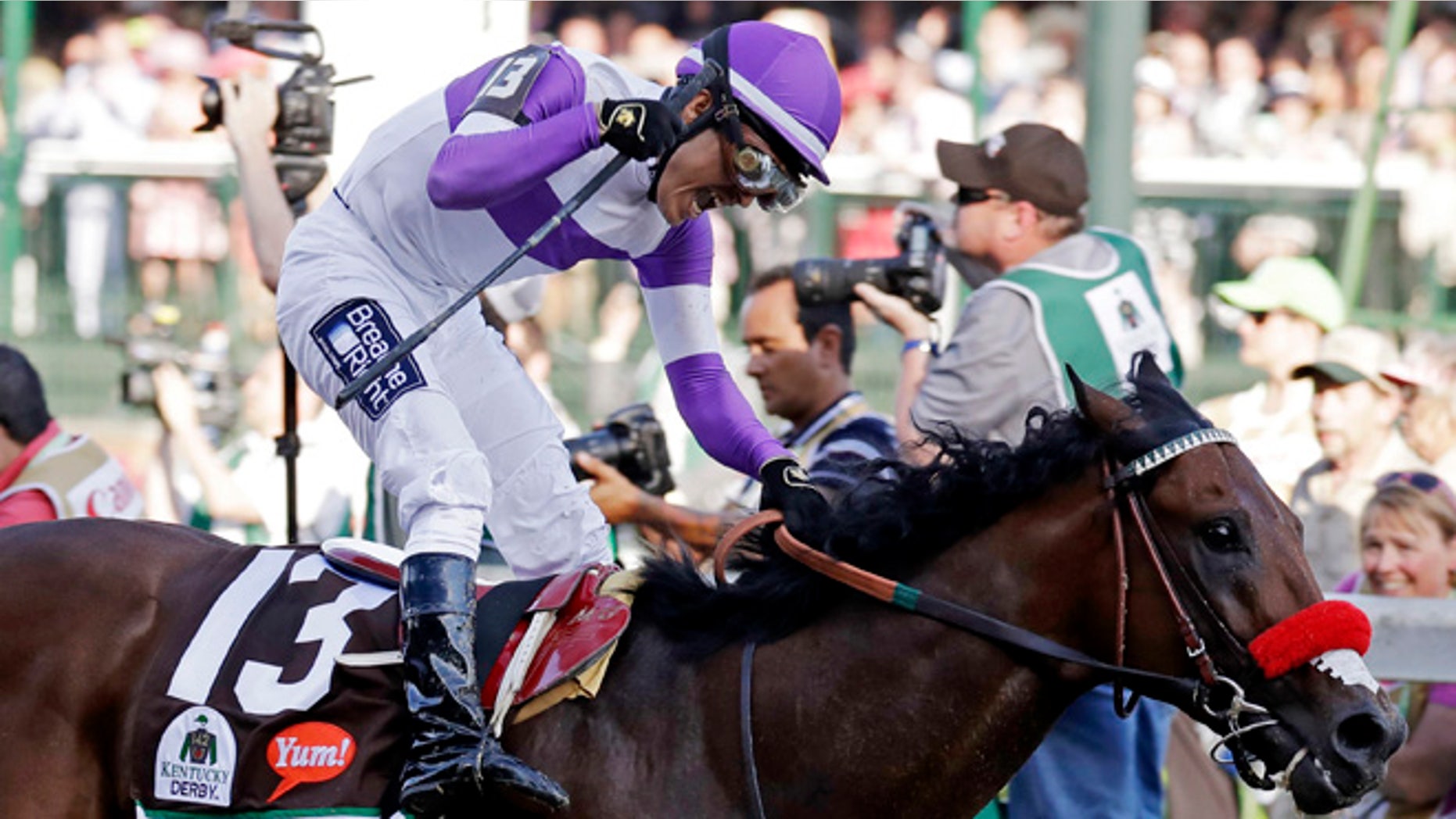 Mario Gutierrez celebrates after riding Nyquist to victory during the 142nd running of the Kentucky Derby horse race at Churchill Downs Saturday, May 7, 2016, in Louisville, Ky. (AP Photo/Garry Jones)