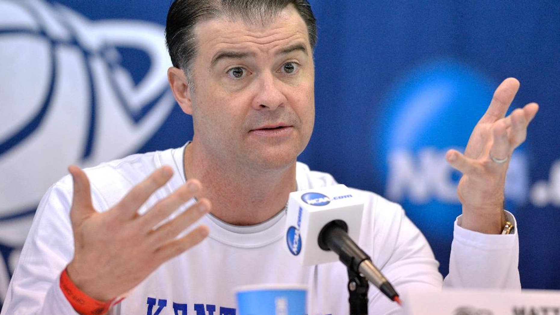 FILE - In this March 23, 2014, file photo, Kentucky head coach Matthew Mitchell answers questions at a news conference for the NCAA women's college basketball tournament in Lexington, Ky. Mitchell begins the season cautioning against expecting too much initially from a Wildcats team that lost forwards DeNesha Stallworth and Samarie Walker. (AP Photo/Timothy D. Easley, File)