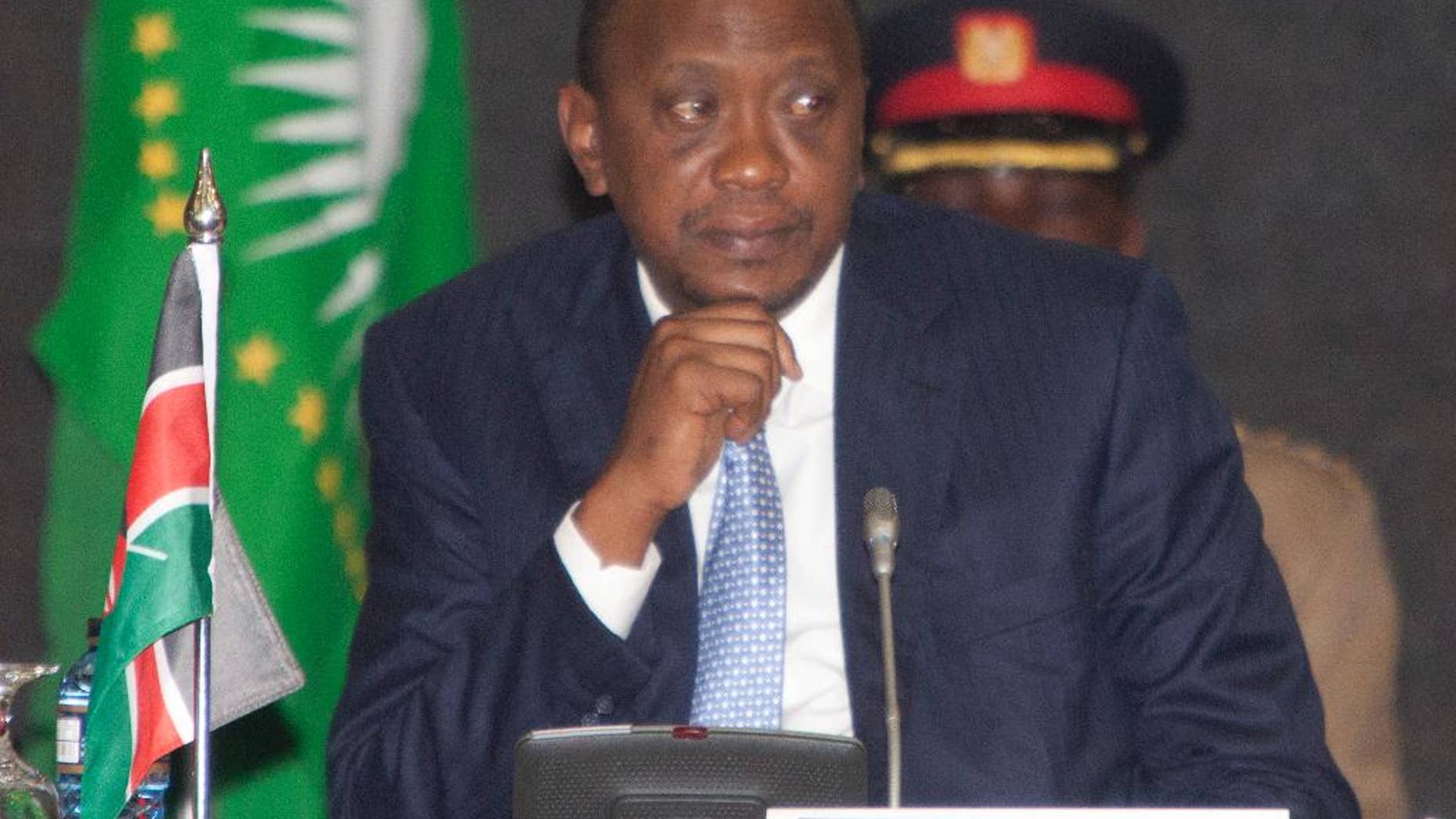 President of Kenya, Uhuru Kenyatta, listens during the AU Summit, Tuesday, Sept. 2, 2014, in Nairobi, Kenya. A one-day African Union Peace and Security Summit started in Nairobi, Kenya, Tuesday. (AP Photo/Sayyid Azim)