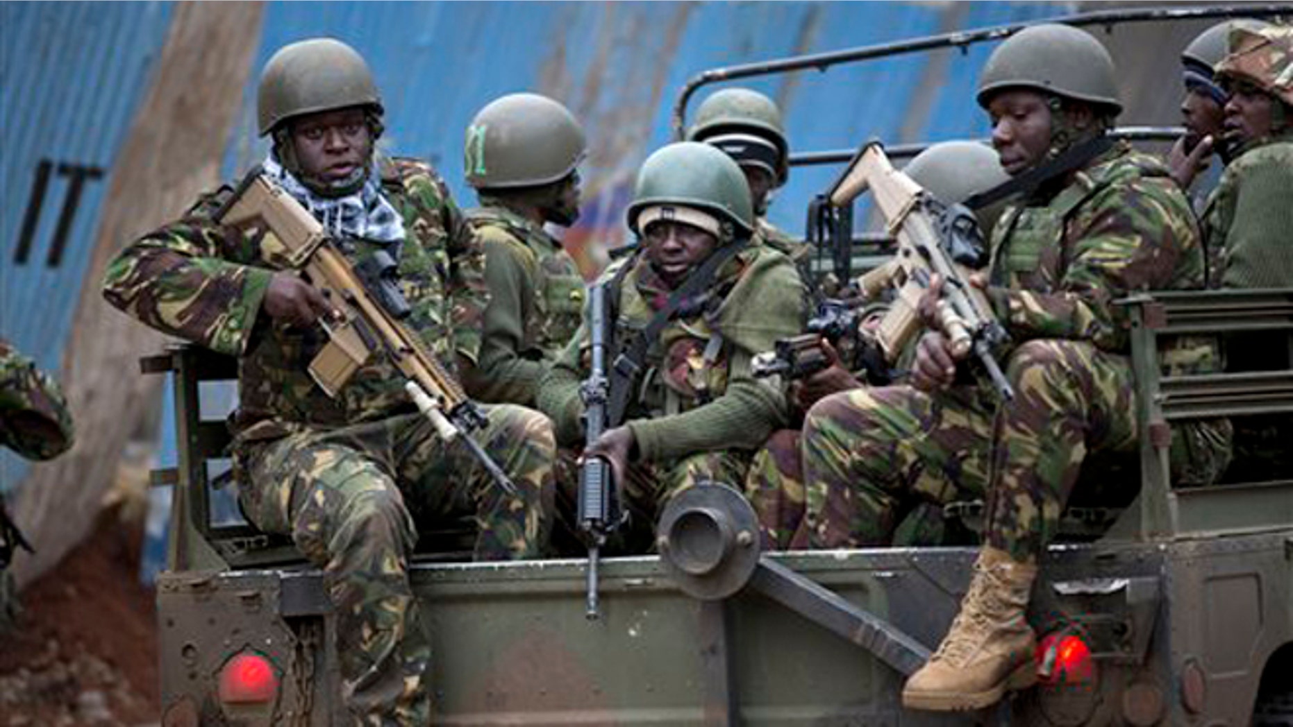 Trucks of soldiers from the Kenya Defense Forces arrive after dawn outside the Westgate Mall in Nairobi, Kenya Sunday, Sept. 22, 2013. Islamic extremist gunmen lobbed grenades and fired assault rifles inside Nairobi's top mall Saturday, killing dozens and wounding over a hundred in the attack. Early Sunday morning, 12 hours after the attack began, gunmen remained holed up inside the mall with an unknown number of hostages. (AP Photo/Ben Curtis)