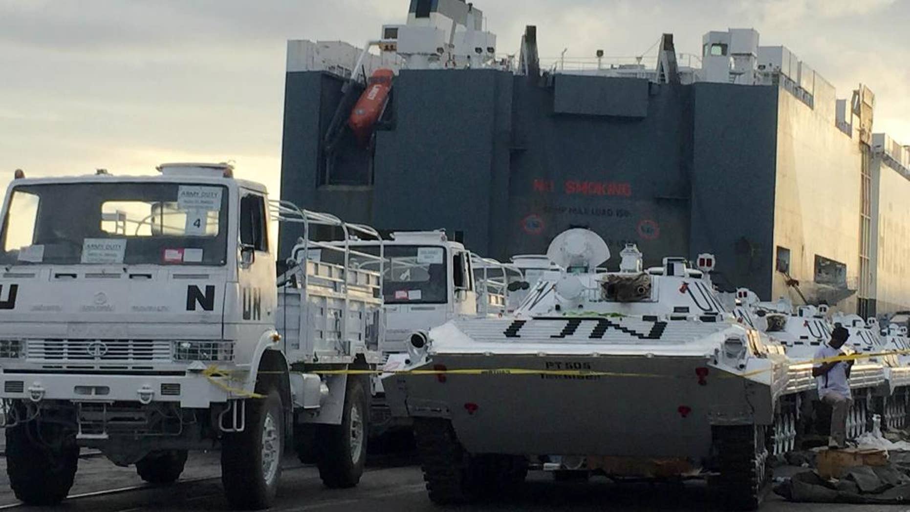 United Nations vehicles are offloaded from a Norwegian ship at the Kenyan port of Mombasa, Wednesday, Sept. 23, 2015. Kenyan security forces searching a Norwegian ship at Mombasa port discovered undeclared weapons among a consignment of U.N. vehicles, local police and the ship's Norwegian owner said Wednesday. (AP Photo)