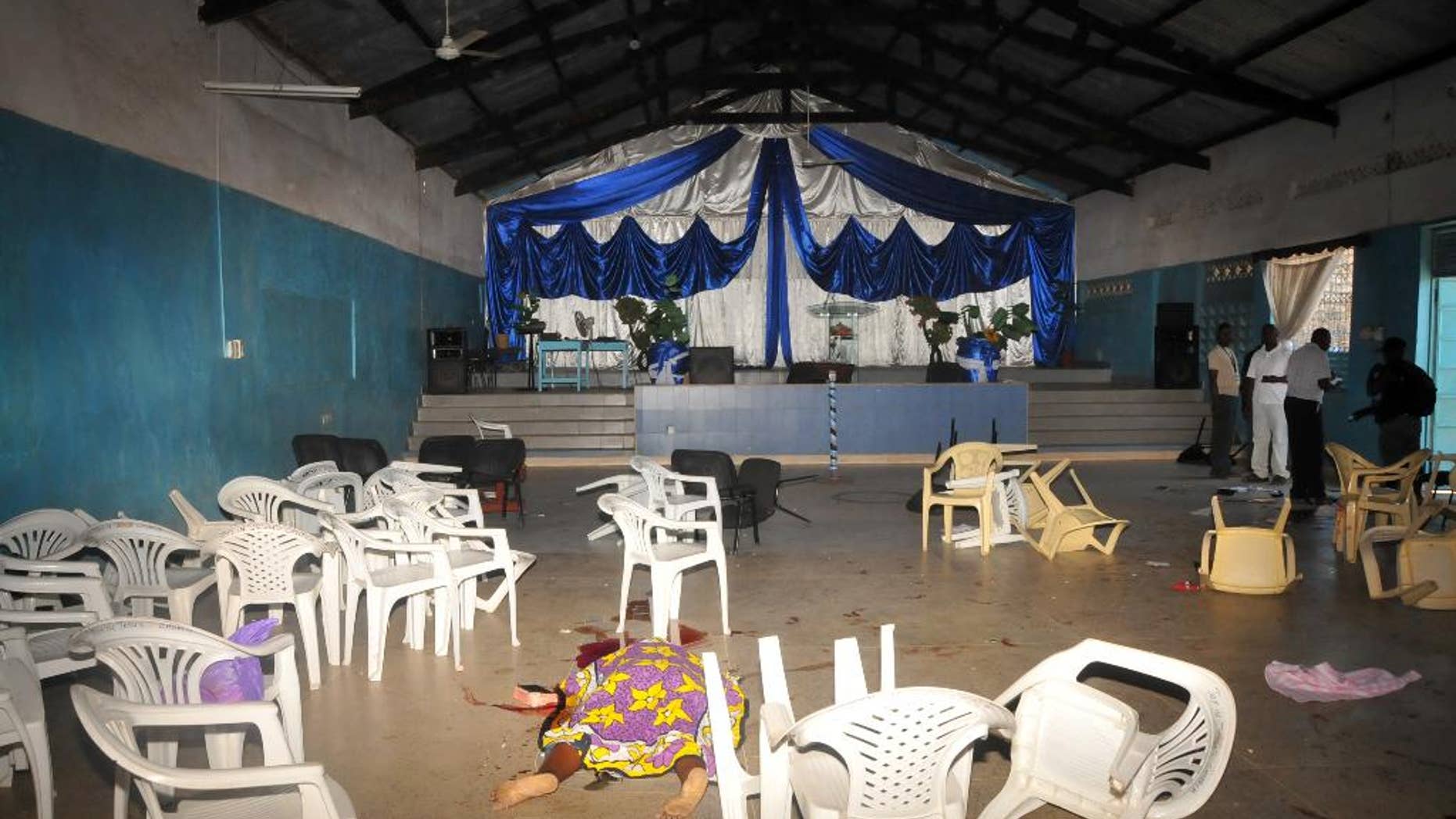 The body of the a worshipper lies on the floor inside Kenyan Joyland church in Likoni, near Mombasa, Kenya Sunday, March 23, 2014. Kenyan officials said three people died after gunmen opened fire in a church just outside the coastal city of Mombasa. The Interior Ministry said Sunday that three gunmen opened fire inside the Joyland Church killing a small number of people. At least 10 were wounded. (AP Photo)