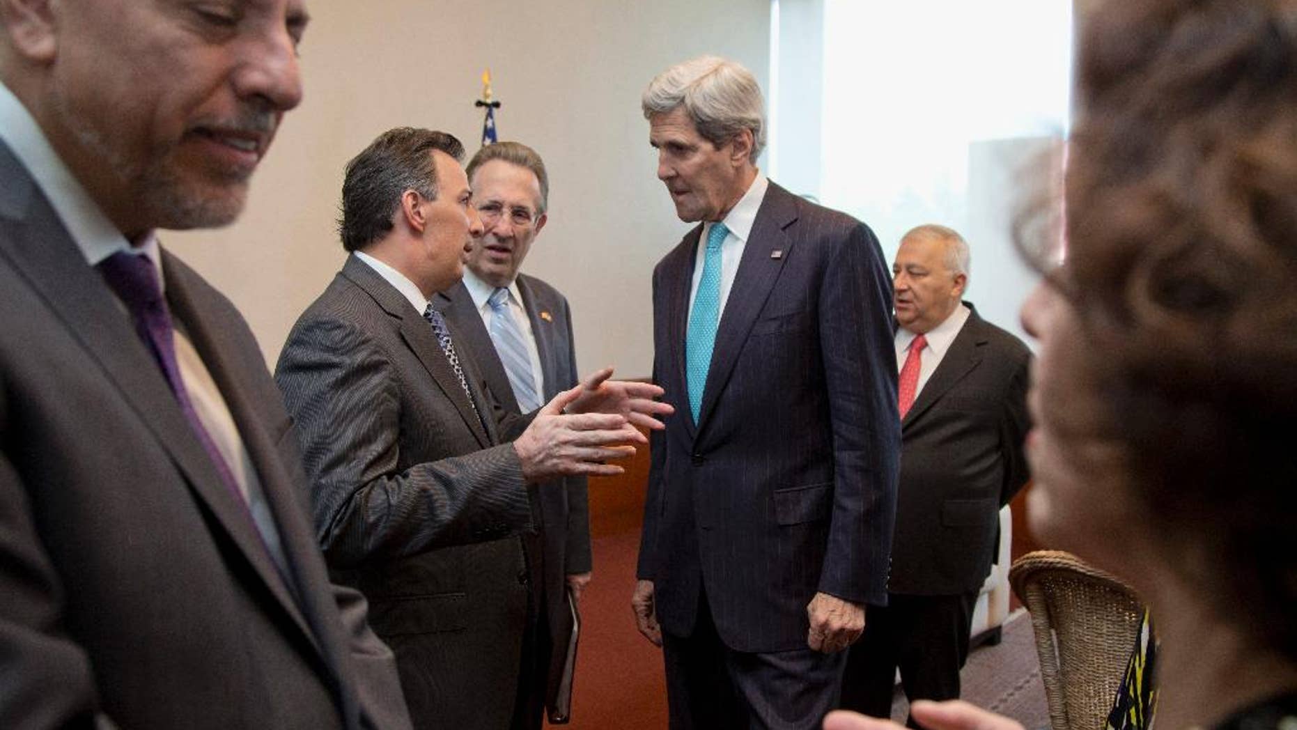 Secretary of State John Kerry talks with with Mexican Foreign Secretary Jose Antonio Meade, accompanied by US Ambassador to Mexico, E. Anthony Wayne, third from left, and Mexican Education Secretary Emilio Chuayffet, fifth from left, before they join a joint bilateral forum on higher education, innovation and research, at the Ministry of Foreign Affairs in Mexico City, Wednesday, May 21, 2014. (AP Photo/Carolyn Kaster, Pool)