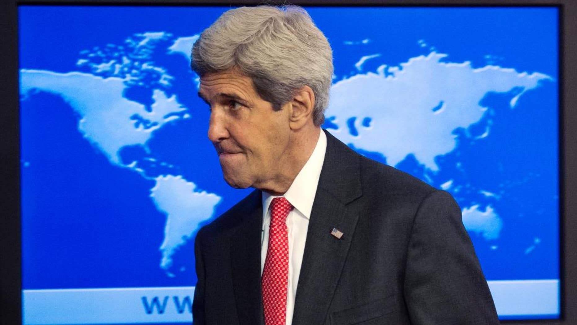 Secretary of State John Kerry leaves after speaking at a news conference at the State Department in Washington, Monday, July 28, 2014, about the 2013 Annual Report on International Religious Freedom. The U.S. says millions of people were forced from their homes because of their religious beliefs last year. (AP Photo/Cliff Owen)