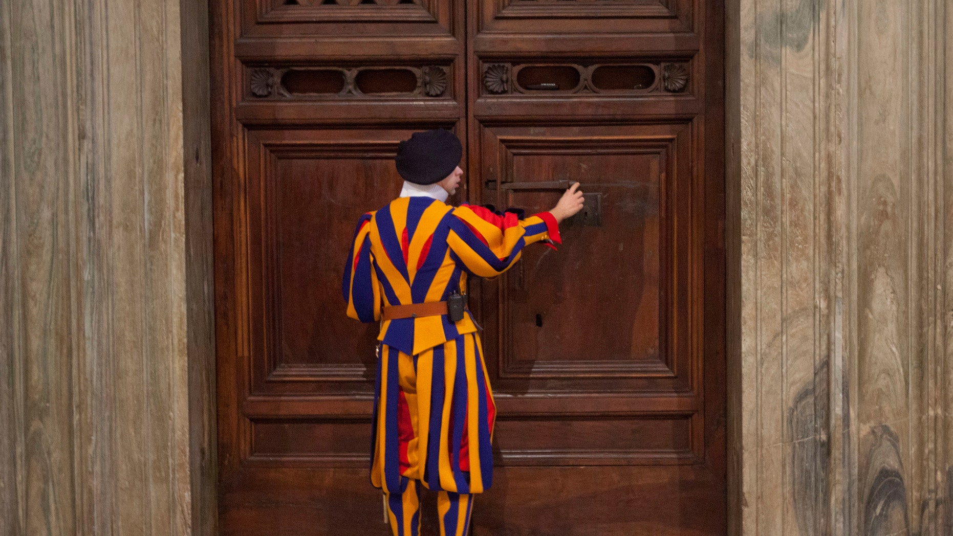 Jan. 14, 2014 - FILE photo: A member of the Swiss Guard unlocks the door to the Sistine Chapel for Secretary of State John Kerry during a tour of the Vatican.