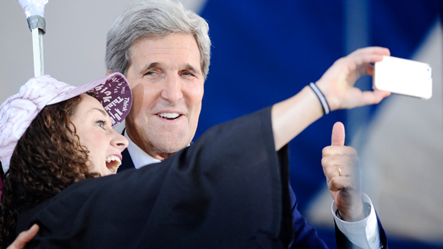 Secretary of State John Kerry, right poses for a selfie with Yale student Ariel Kirshenbaum during Class Day at Yale University, Sunday, May 18, 2014, in New Haven, Conn. (AP Photo/Jessica Hill)