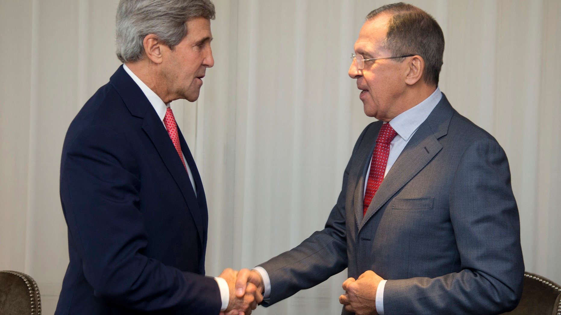 Nov. 23, 2013: U.S. Secretary of State John Kerry (L) and Russia's Foreign Minister Sergei Lavrov shake hands during a photo opportunity prior to their meeting, in Geneva.