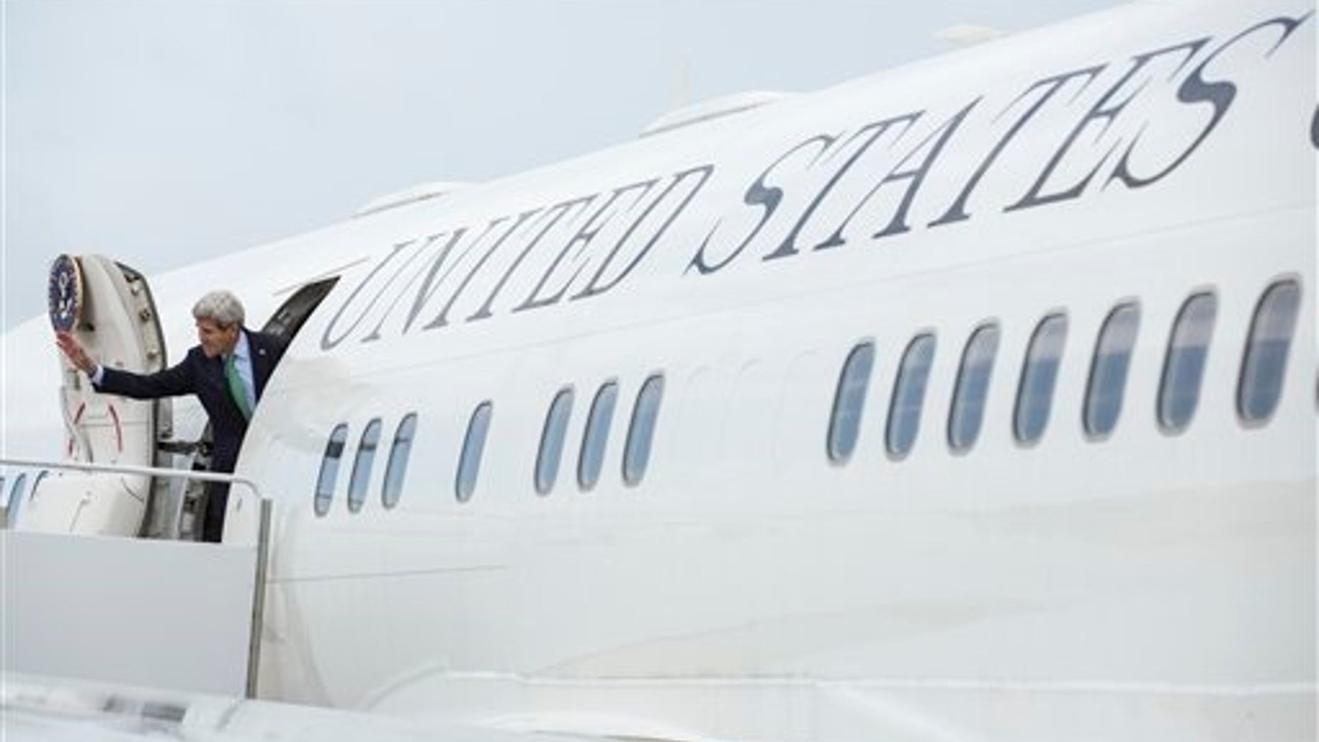 U.S. Secretary of State John Kerry waves as he boards his aeroplane before departing for Russia and Turkey from Andrews Air Force Base in Maryland, Monday May 11, 2015. (Joshua Roberts/Pool Photo via AP)
