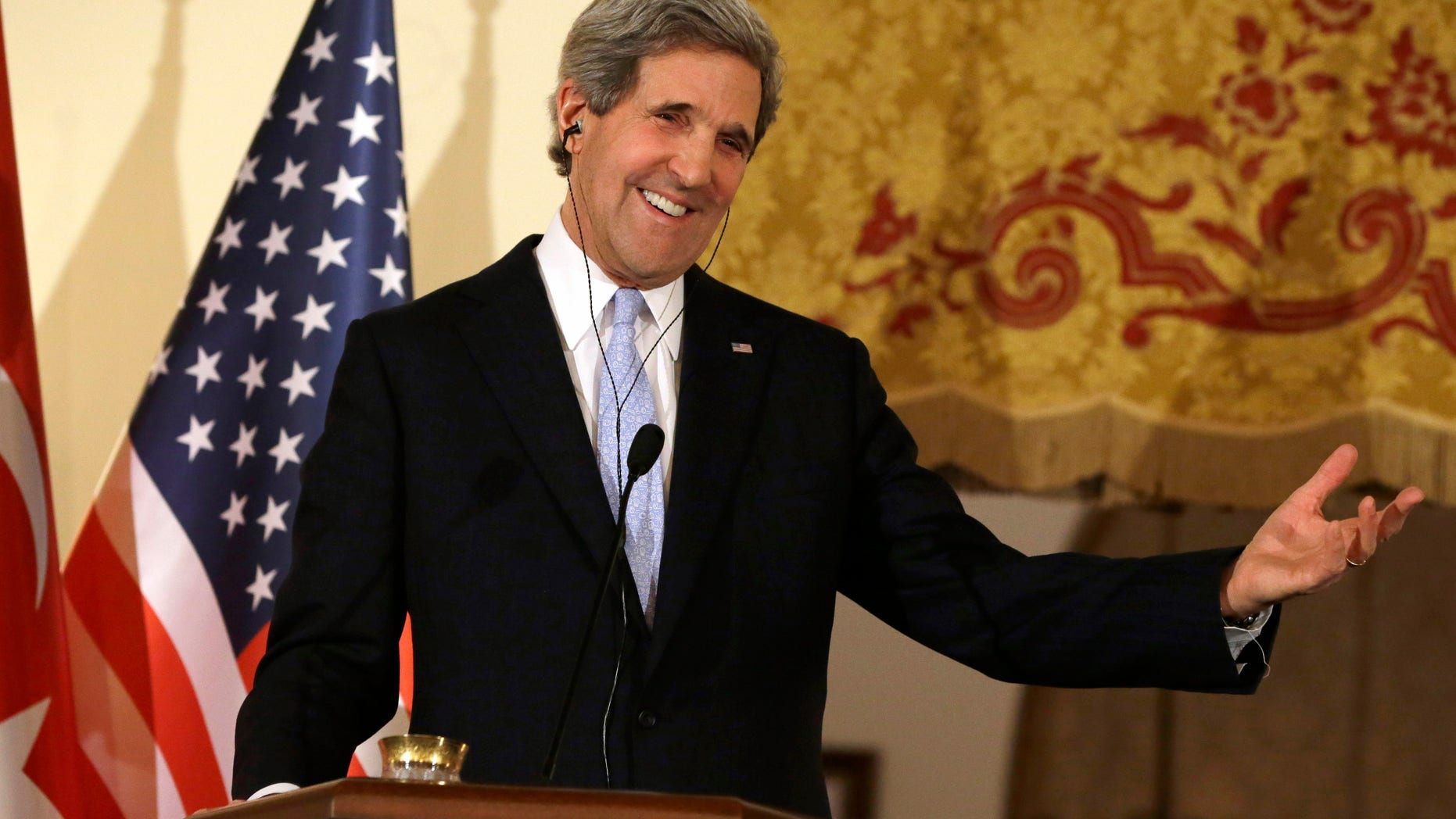 FILE - In this March 1, 2013, photo, U.S. Secretary of State John Kerry speaks at a news conference with Turkish Foreign Minister Ahmet Davutoglu at Ankara Palace in Ankara, Turkey. With the smile of a seasoned politician, a flair for languages and a vast repertoire of personal anecdotes, Kerry schmoozed and cajoled his way through Europe and the Middle East on his first trip abroad as America's top envoy over the past 10 days. (AP Photo/Jacquelyn Martin, Pool, file)