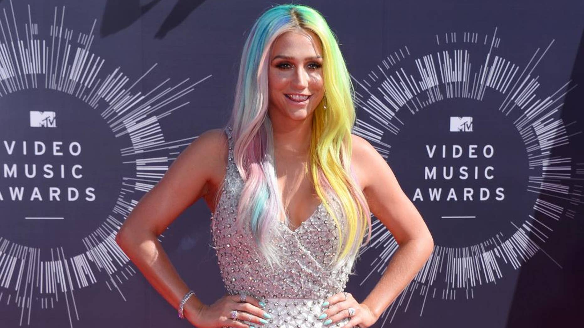 FILE - In this Aug. 24, 2014 file photo, Kesha arrives at the MTV Video Music Awards at The Forum in Inglewood, Calif. Attorneys for music producer Lukasz Gottwald, known professionally as Dr. Luke, filed a motion in Los Angeles Superior Court on Monday, Nov. 17, 2014, seeking the dismissal of claims made by the pop singer, Kesha, that she was raped by her mentor. Gottwald's filings argue that the claims are barred by the statue of limitations. (Photo by Jordan Strauss/Invision/AP, File)