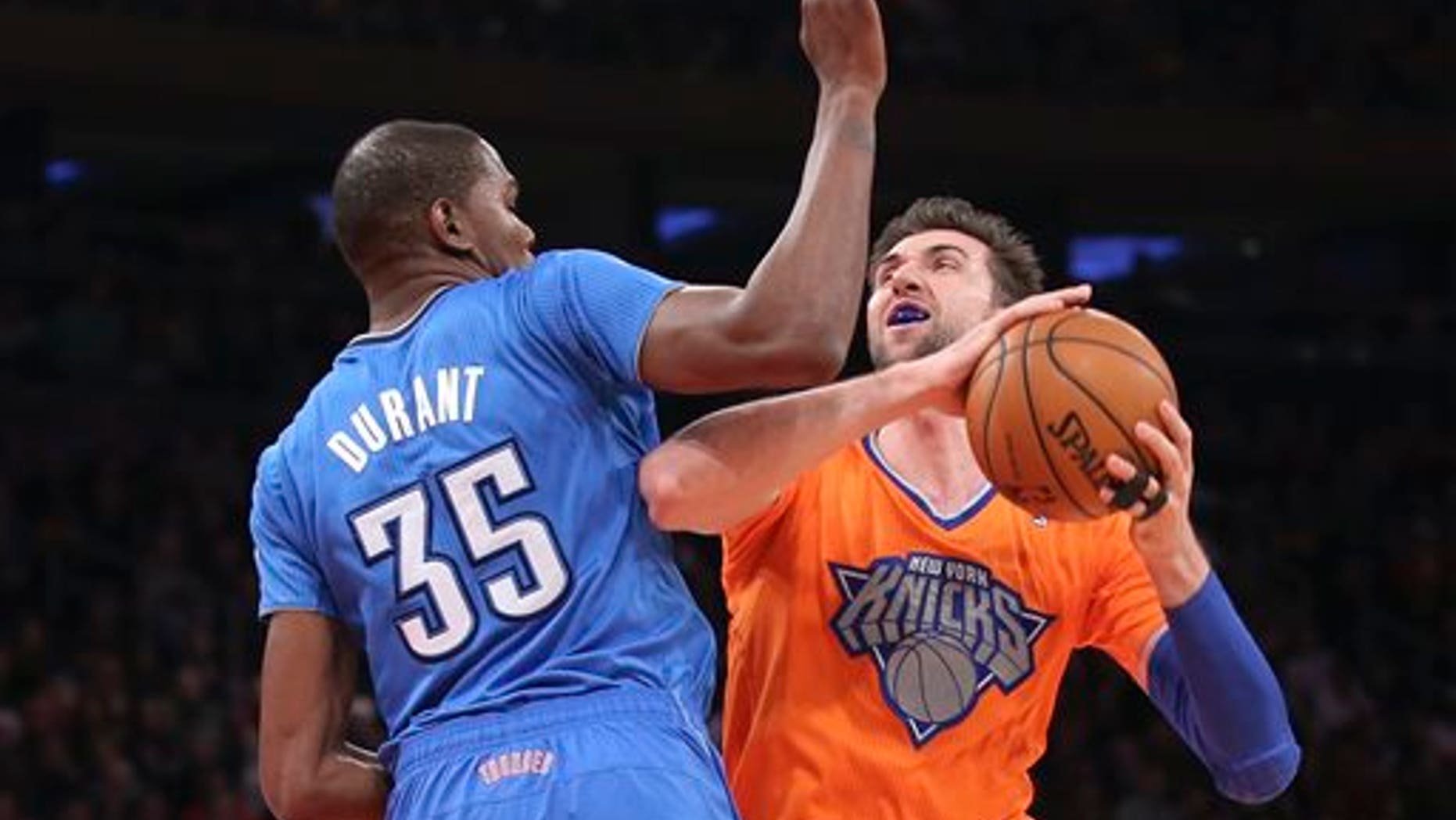 Knicks' Andrea Bargnani shoots against Oklahoma City Thunder's Kevin Durant at Madison Square Garden, Wednesday, Dec. 25, 2013, in New York.