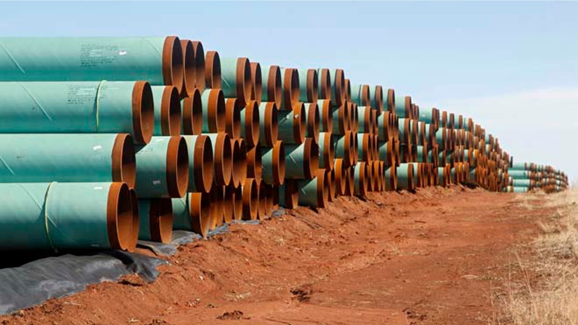In this Feb. 1, 2012 file photo, miles of pipe ready to become part of the Keystone Pipeline are stacked in a field near Cushing, Okla.