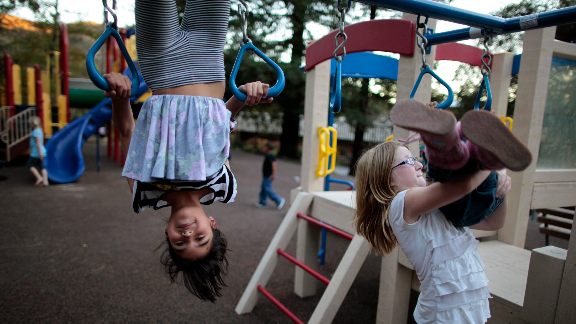 Lindzy Earp (2nd R), 10, plays in the playground at Hope Gardens Family Center, a shelter for homeless women and children, run by Union Rescue Mission on 77 acres (0.31 square km) of countryside away from Skid Row, on the outskirts of Los Angeles, California January 25, 2012. One in 45 children, totalling 1.6 million, is homeless, the highest number in United States' history, according to a 2011 study by the National Center on Family Homelessness. California is ranked the fifth highest state in the nation for its percentage of homeless children. Picture taken January 25, 2012. REUTERS/Lucy Nicholson (UNITED STATES - Tags: SOCIETY TPX IMAGES OF THE DAY)